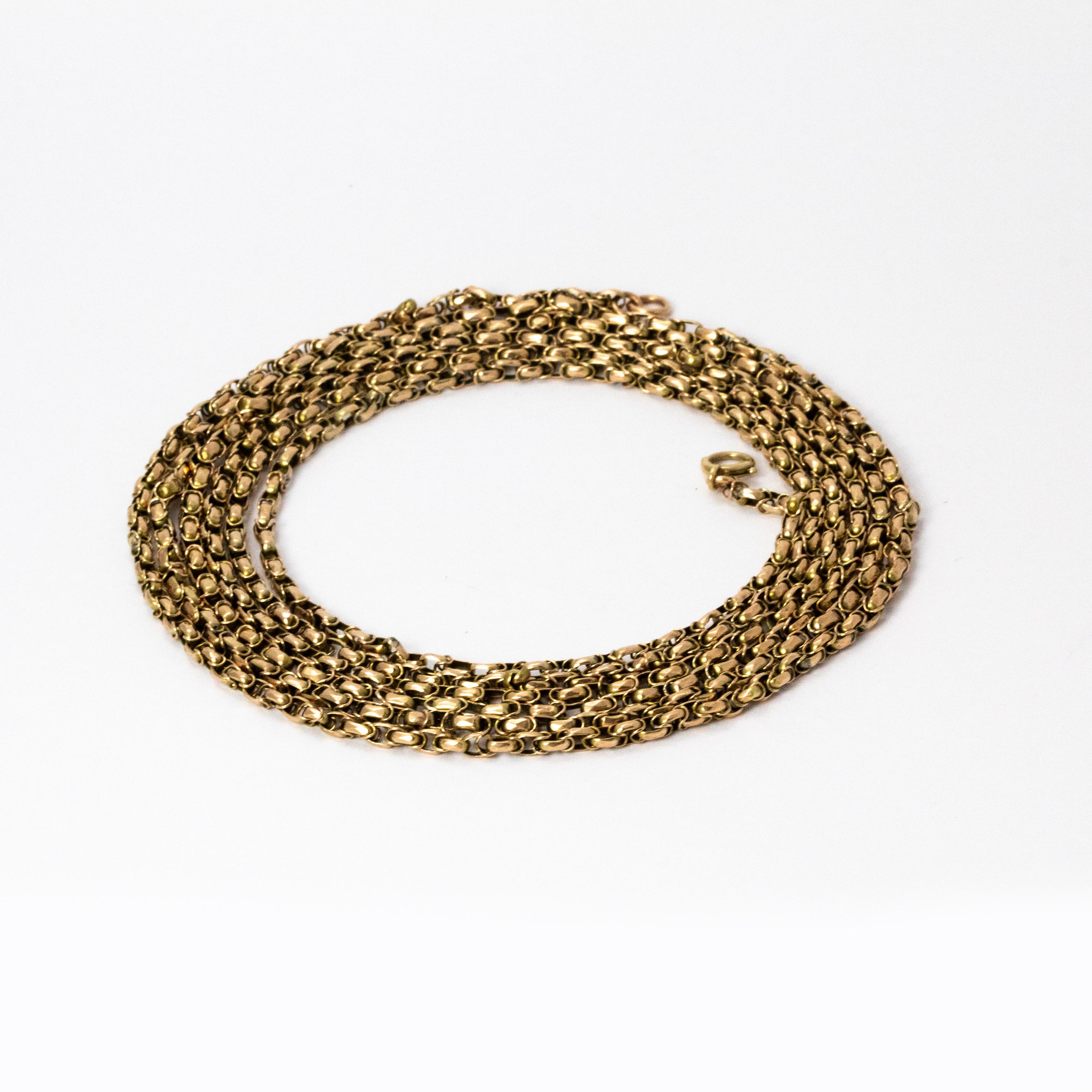 A fantastic Edwardian long guard chain necklace measures an impressive 75 cm in length, making it a fantastically wearable piece. Modelled in bright yellow 9 karat gold.