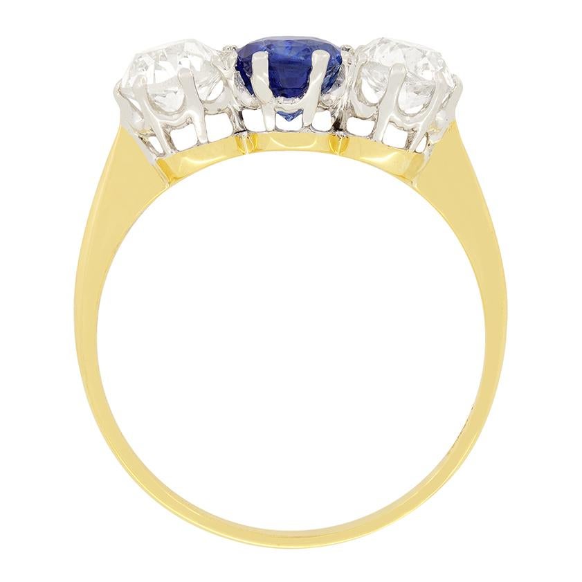 A stunning Edwardian trilogy ring set with a lovely 1.30 carat Sapphire to the centre and with two 0.65 carat old cut diamonds, one to either side. The diamonds are H in colour and VS-SI in clarity. All stones are beautifully presented in platinum