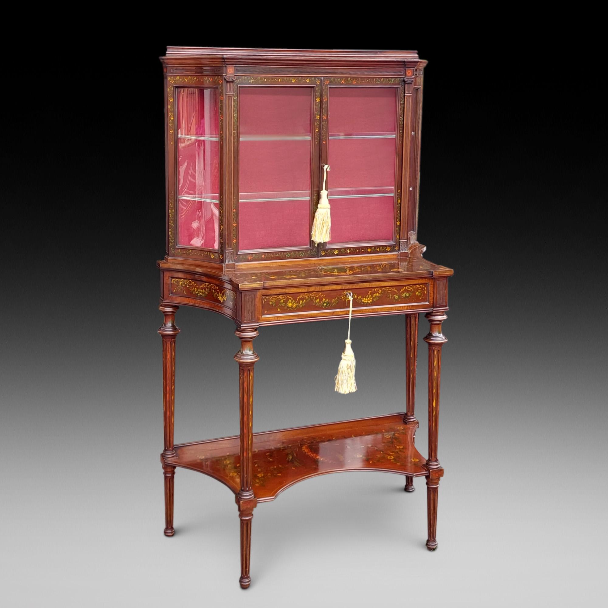 Edwards and Roberts Edwardian Painted Mahogany Glazed Display Cabinet with concave glass side panels and sides, single drawer and undershelf, raised on reeded tapering feet 36