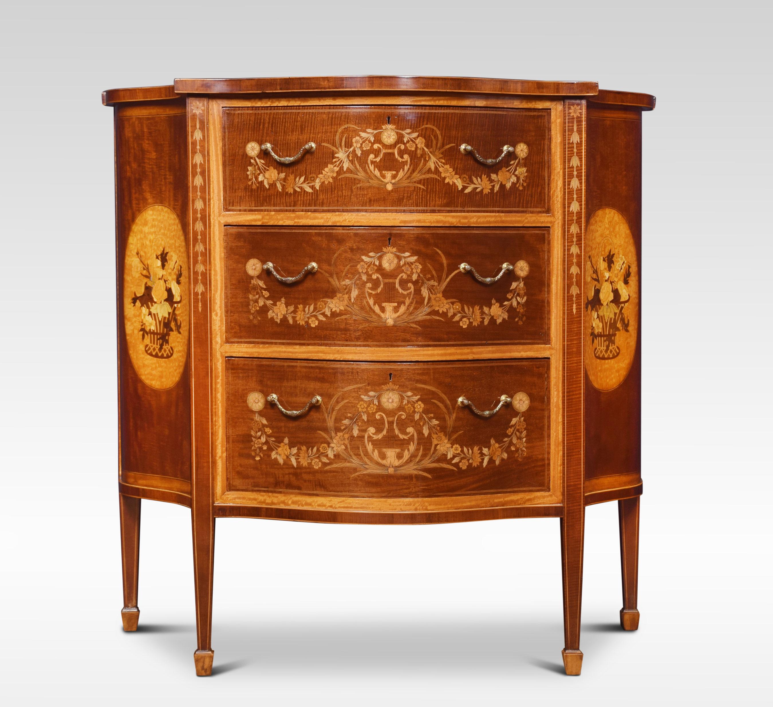 Edwards and Roberts serpentine chest of drawers in the Hepplewhite taste. The shaped serpentine top with satinwood inlaid oval panel, with a floral spray and ribbon tie within stringing and crossbanded border. Above three graduated drawers with