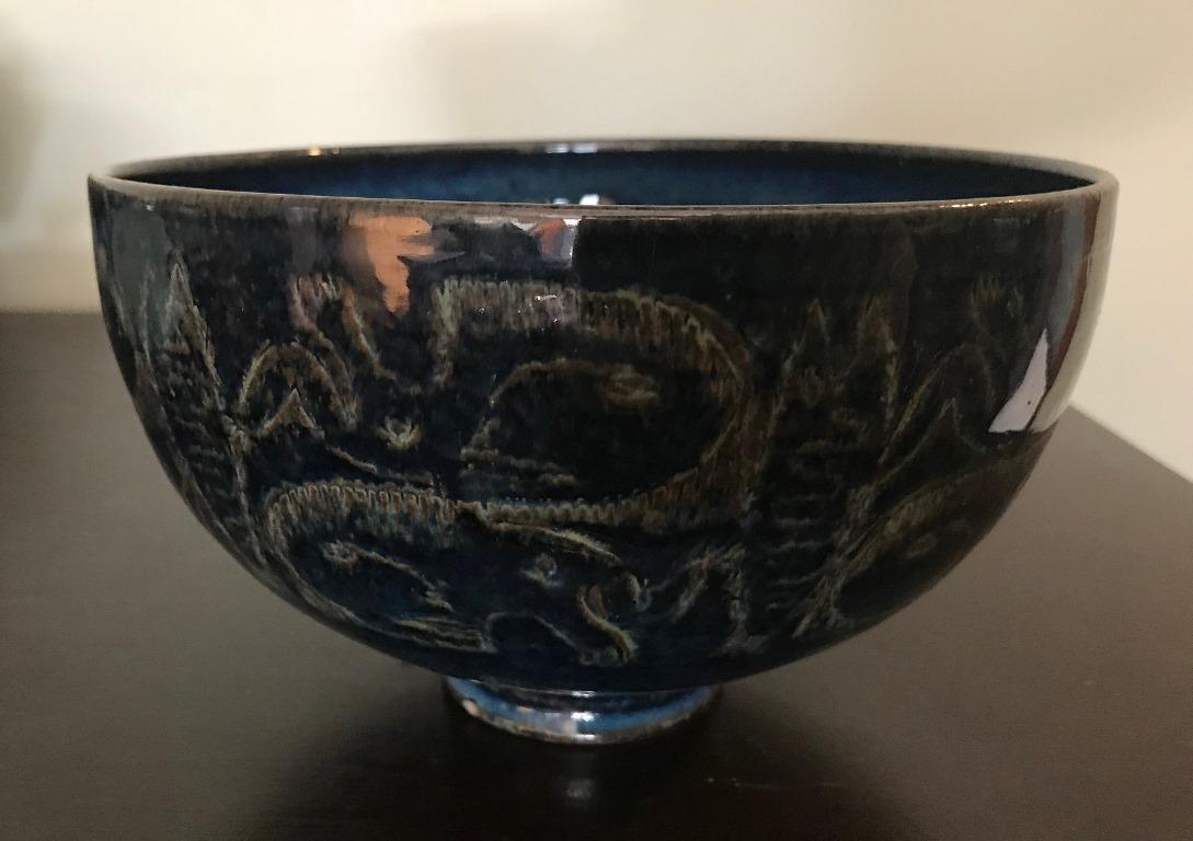 A gorgeous and relatively large pottery/ stoneware bowl by fame American ceramists couple Mary and Edwin Scheier. 

The bowl has a beautiful sung inspired brilliant blue glaze and is decorated with abstract fish, animals, and Primitive figures