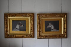 A white and tan short-haired terrier; and A white short-haired terrier