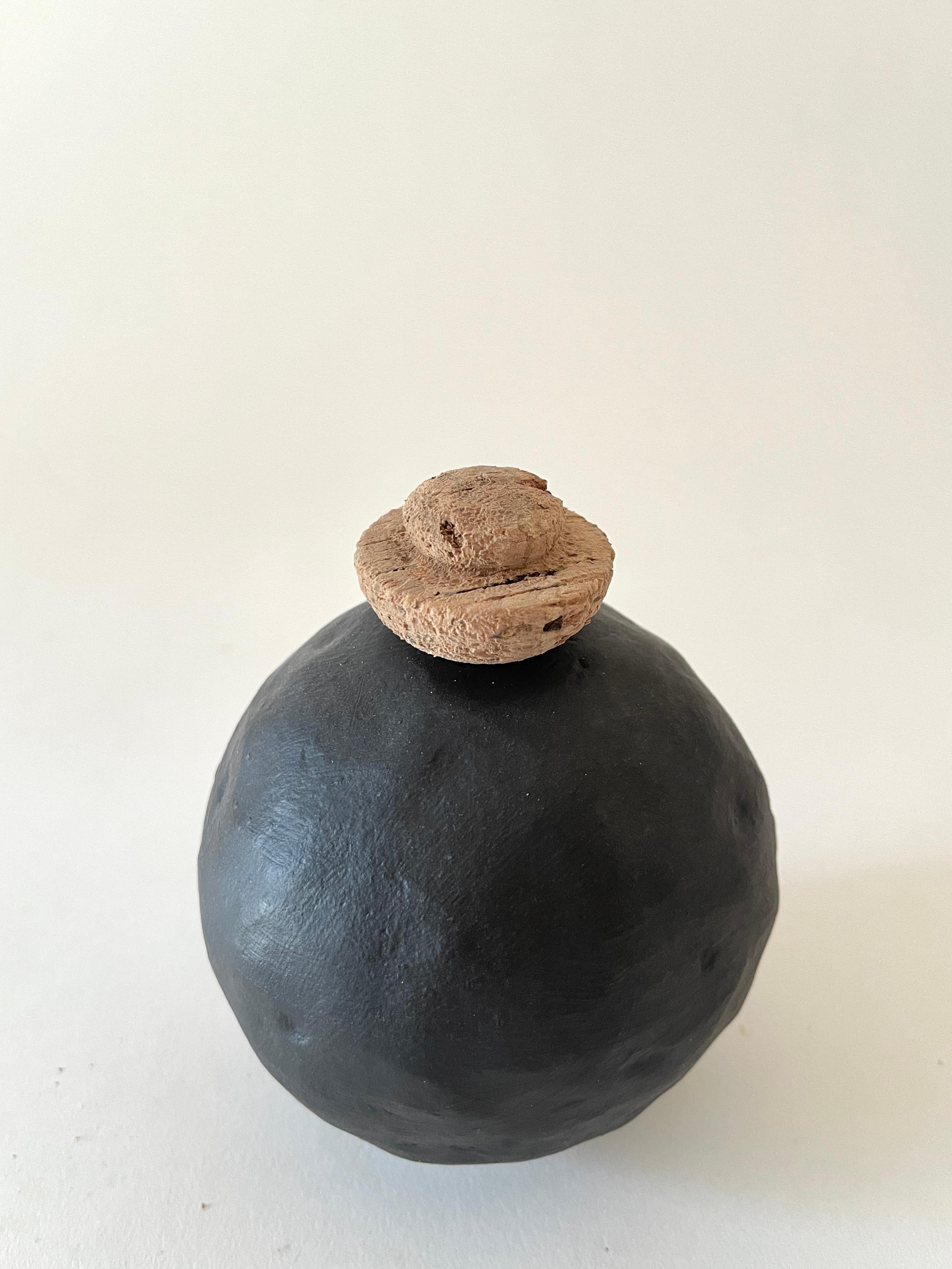 Edwina Black Vase by Meg Morrison
One of a kind.
Materials: Ceramic, cork.
Dimensions: Ø 10 x H 13 cm.

All sizes are approximate. Although vases are watertight condensation may form on the bottom. Please protect delicate surfaces. Please