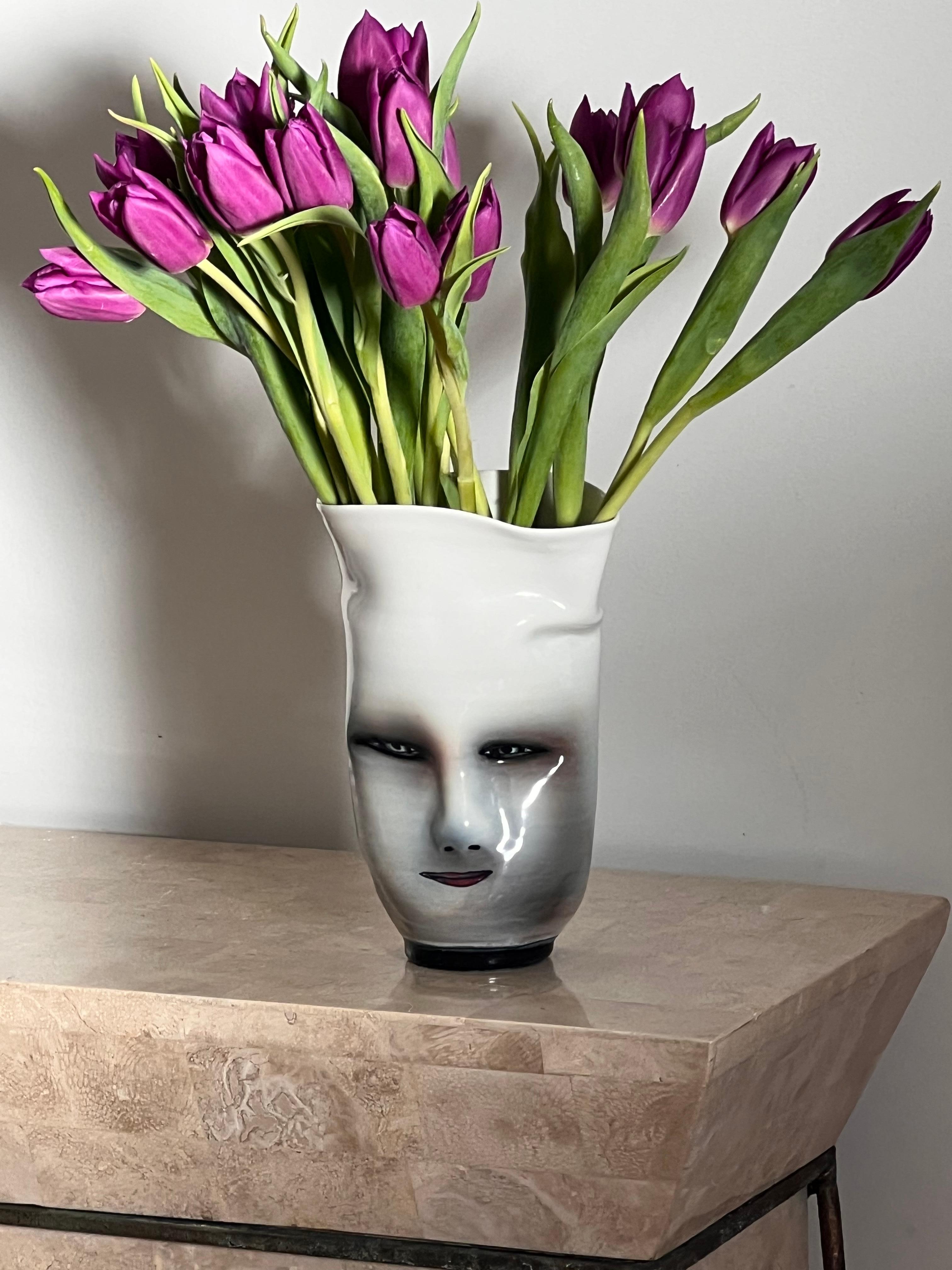 A very unique and somewhat eerie postmodern ceramic face vase by artist Bing Gleitsman, 1996. Painted and glazed, and signed and dated. Tones of violet, shade, and blush. Pick up in LA or worldwide shipping available.
Dimensions: 
5” W x 3.5” D x