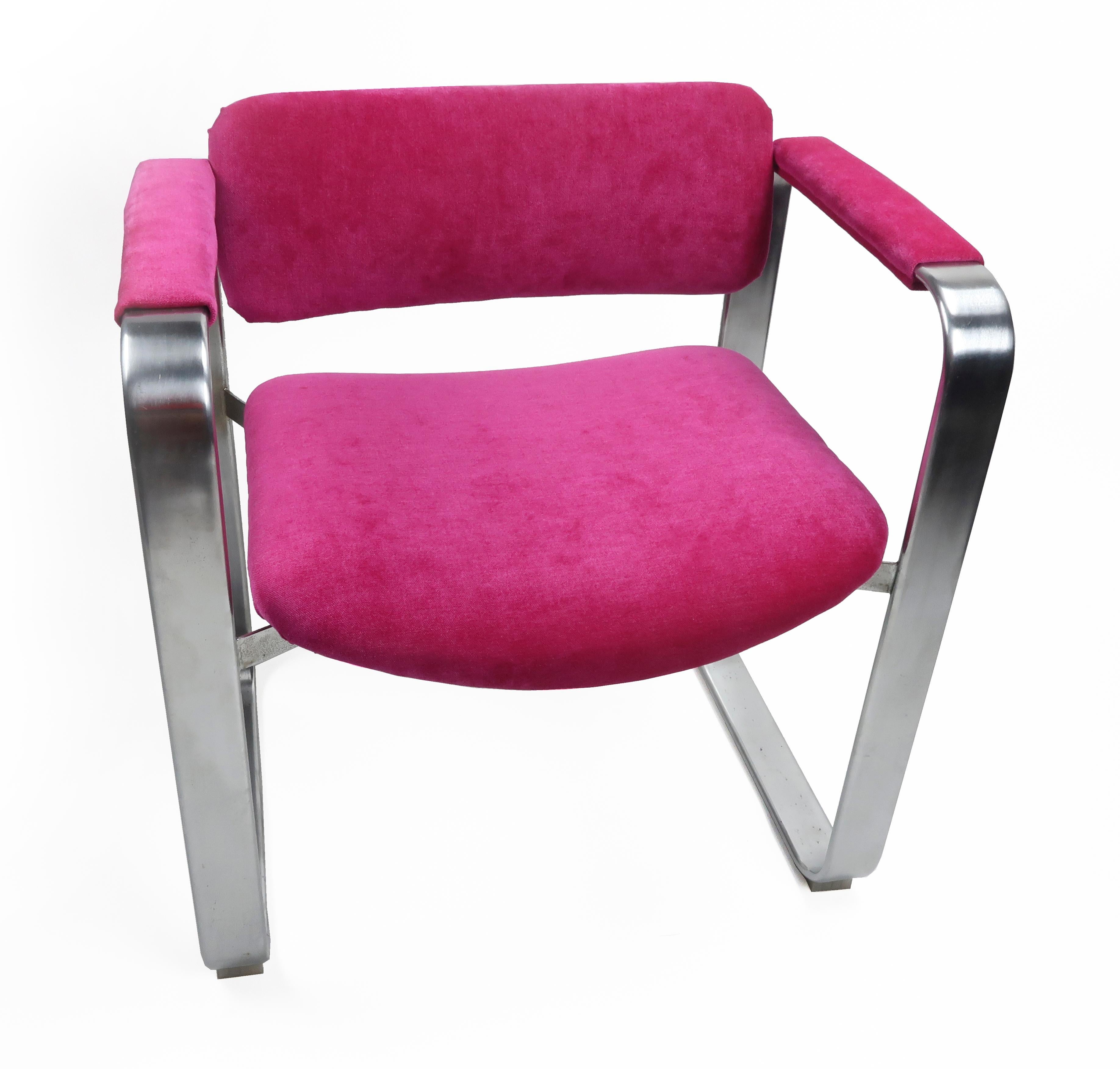 A dazzling Scandinavian Modern executive armchair by famed Finnish designer Eero Aarnio for Mobel Italia (1968). The frame has a satin chrome finish with a stainless back. And new hot pink/fucshia chenille upholstery on the seat, back and