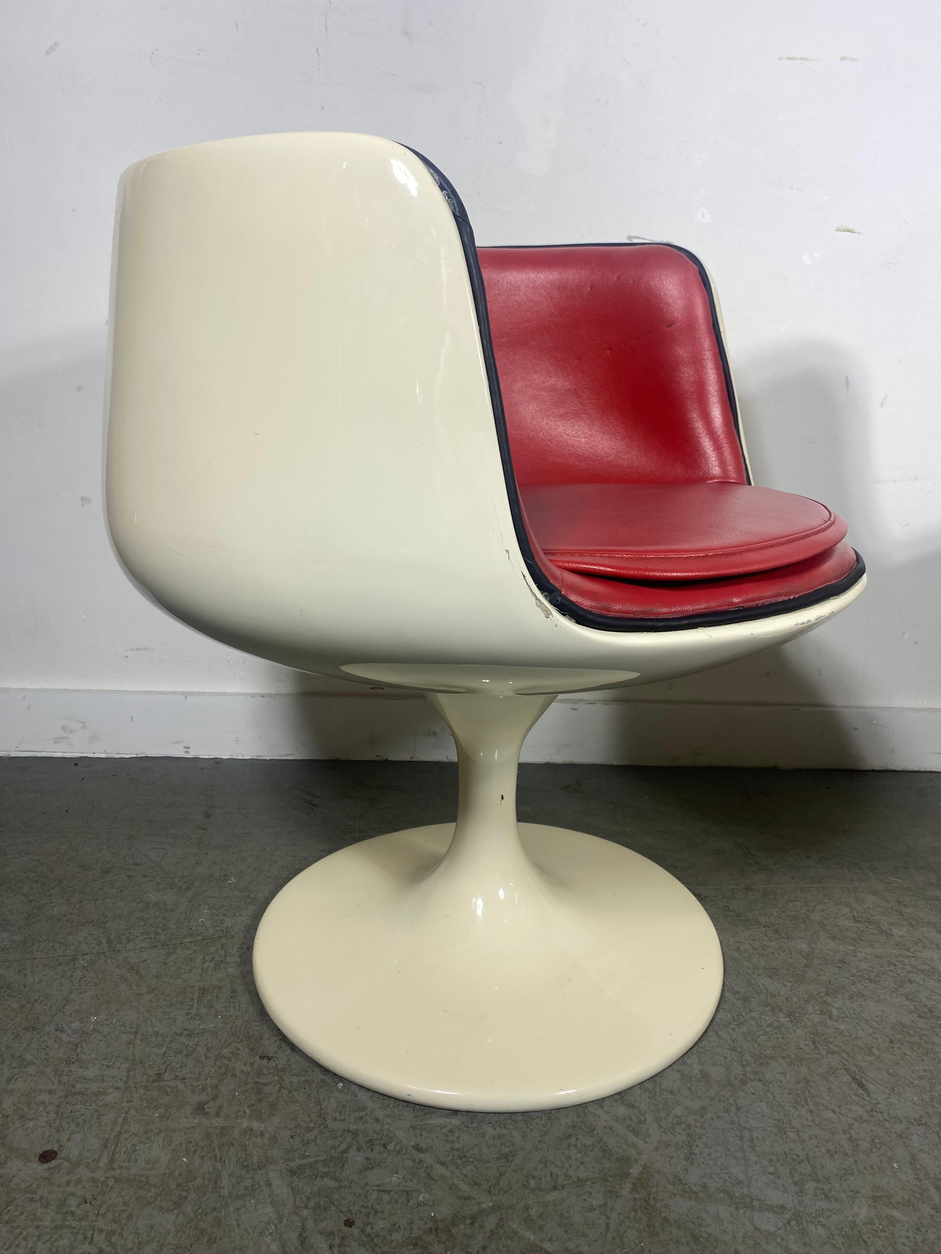 Original Cognac V.S.O.P chairs designed by Eero Aarnio and manufactured by Asko in Finland.

Sold as a set of 2
White fiberglass trumpet-shaped base with a swivel mechanism.
The seats and cushions in original rede leather upholstery.:  Nice original