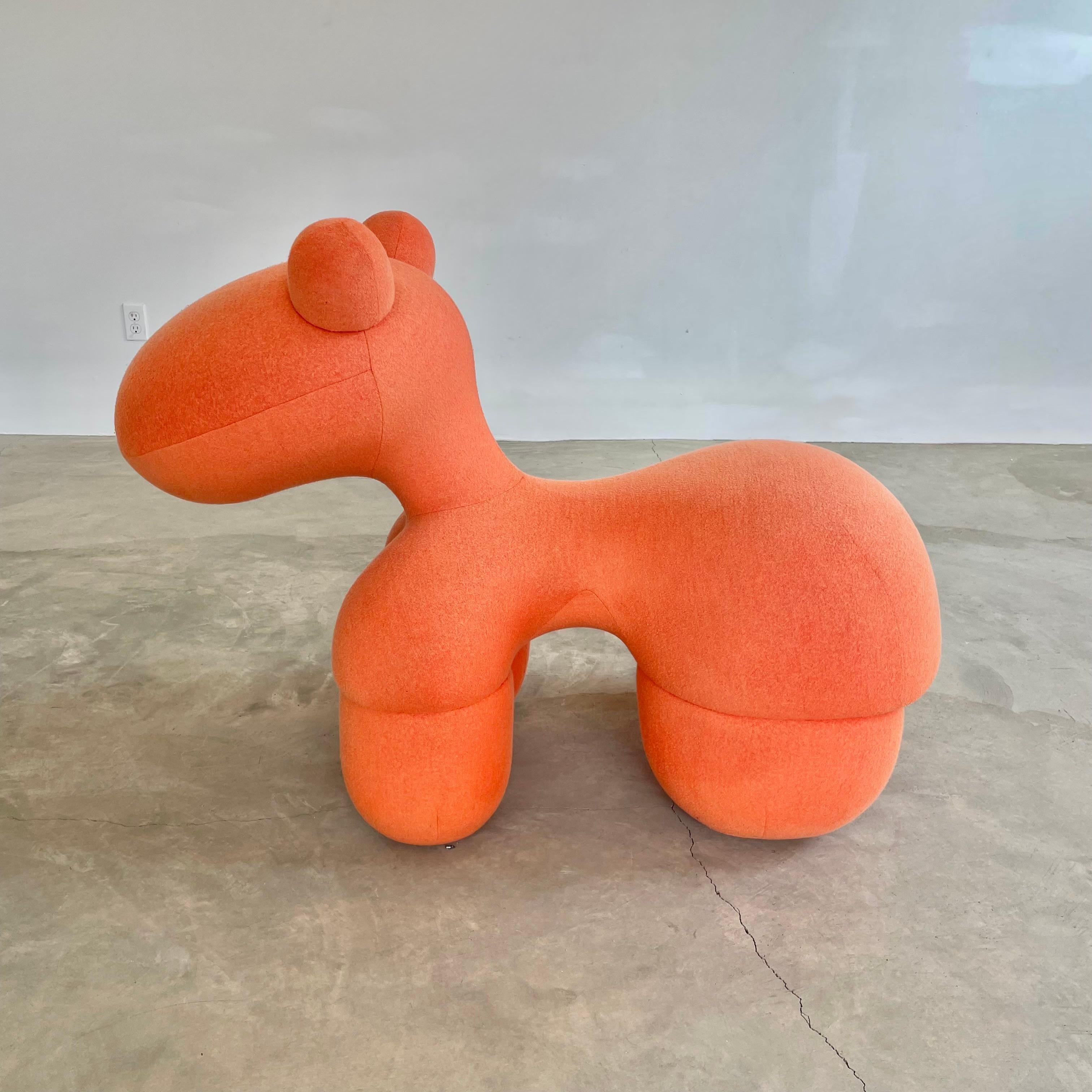 Rare, playful and iconic pony chair by designer Eero Aarnio in orange wool. The pony chair was designed by the Finnish designer in 1973 and has been a staple of contemporary design ever since. Internal metal frame. Extremely sturdy seat and an eye