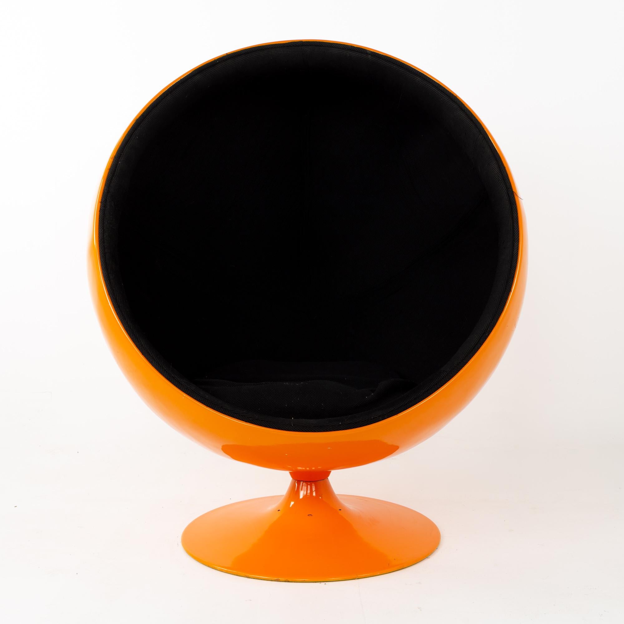 Eero Aarnio style Mid Century orange ball chair.
This chair is 39.5 wide x 32.25 deep x 48 inches high, with a seat height of 17 inches

This piece is available in what we call restored vintage condition. Upon purchase it is thoroughly cleaned and