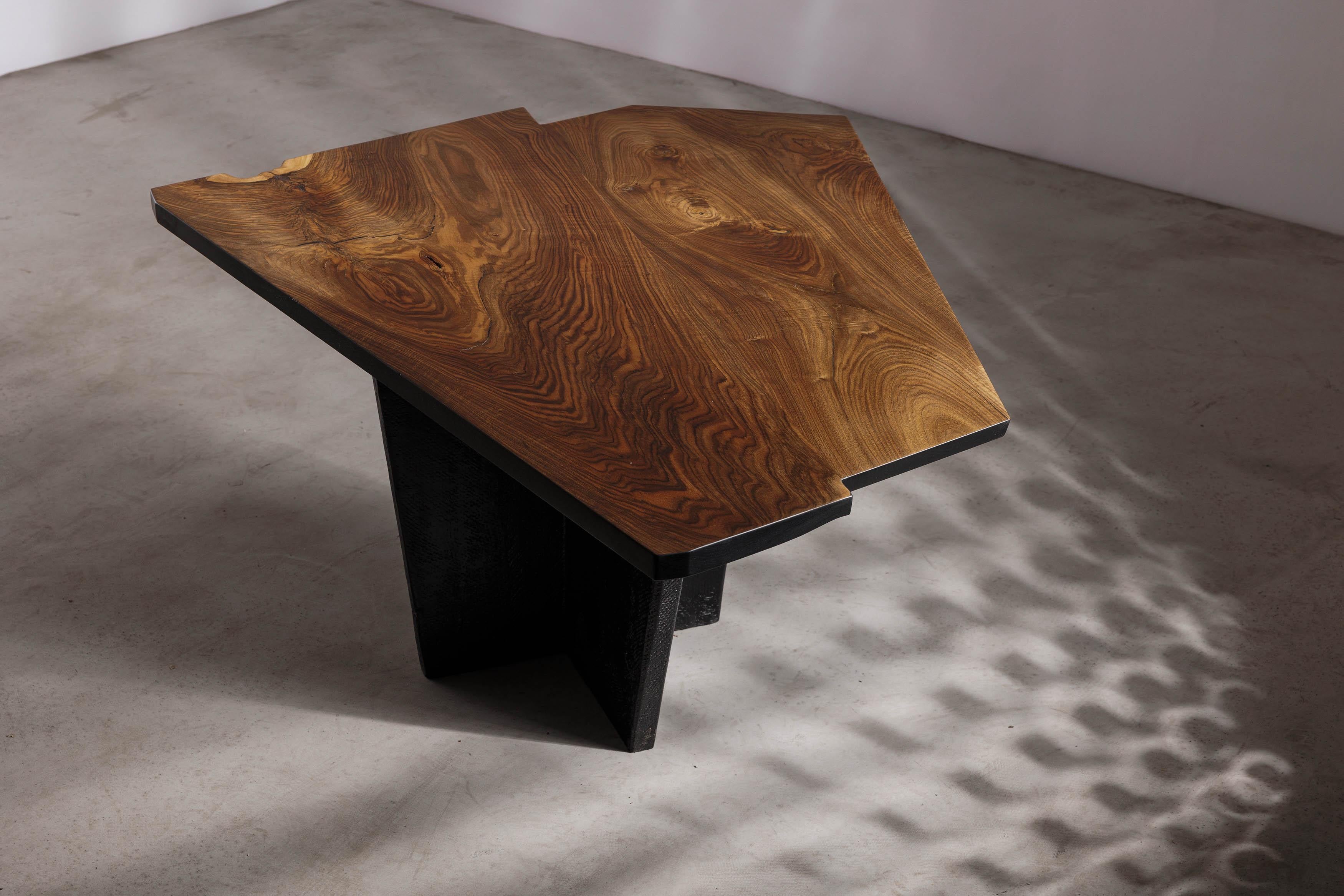 Introducing our stunning smaller dining table from Eero Moss studio's latest collection, designed to embody the beauty of brutalism and organic textures in a minimalist form. Expertly crafted with the finest materials and a keen eye for detail, this