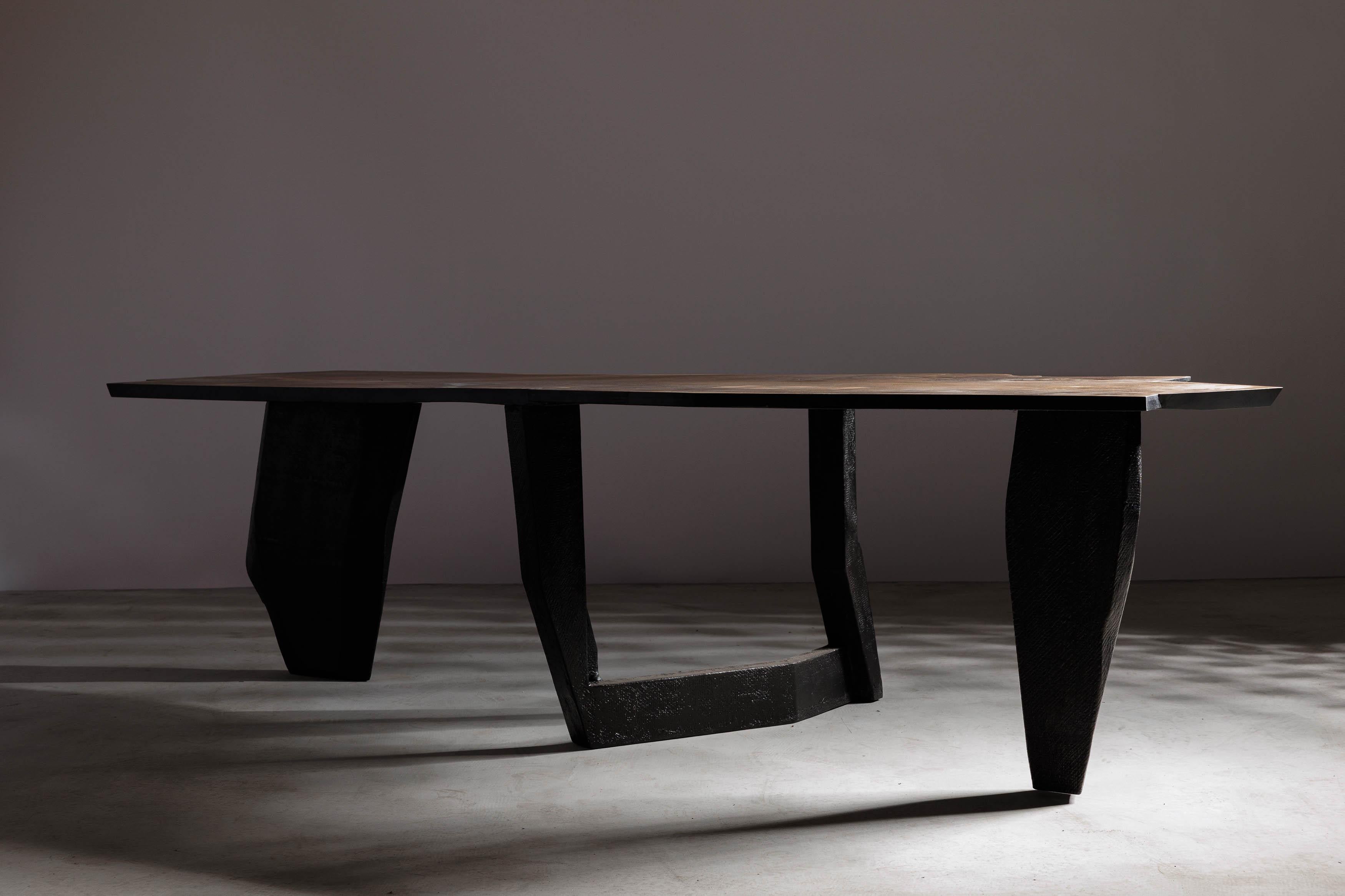 Experience the intersection of brutalism and minimalism with our stunning dining table from Eero Moss studio's latest collection. Crafted with the utmost care and attention to detail, this piece showcases the organic beauty of natural materials