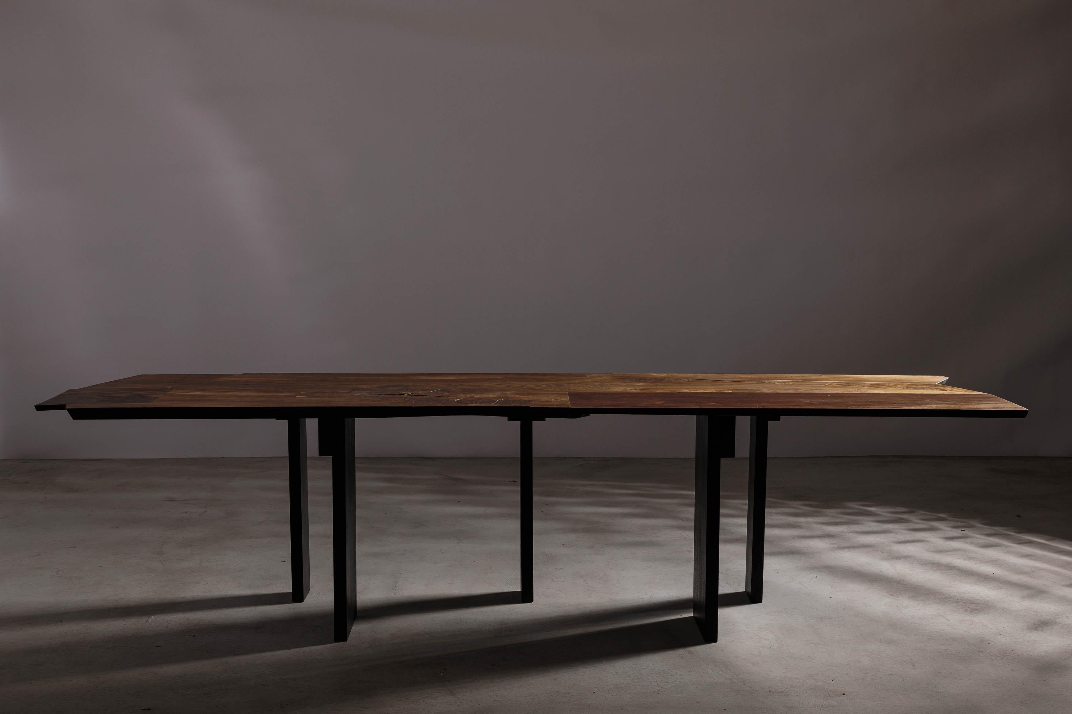Introducing our stunning dining table, a seamless blend of brutalism and minimalism, featuring an organic texture that is both rugged and refined. This masterpiece is part of our latest collection, a tribute to the architectural movement that