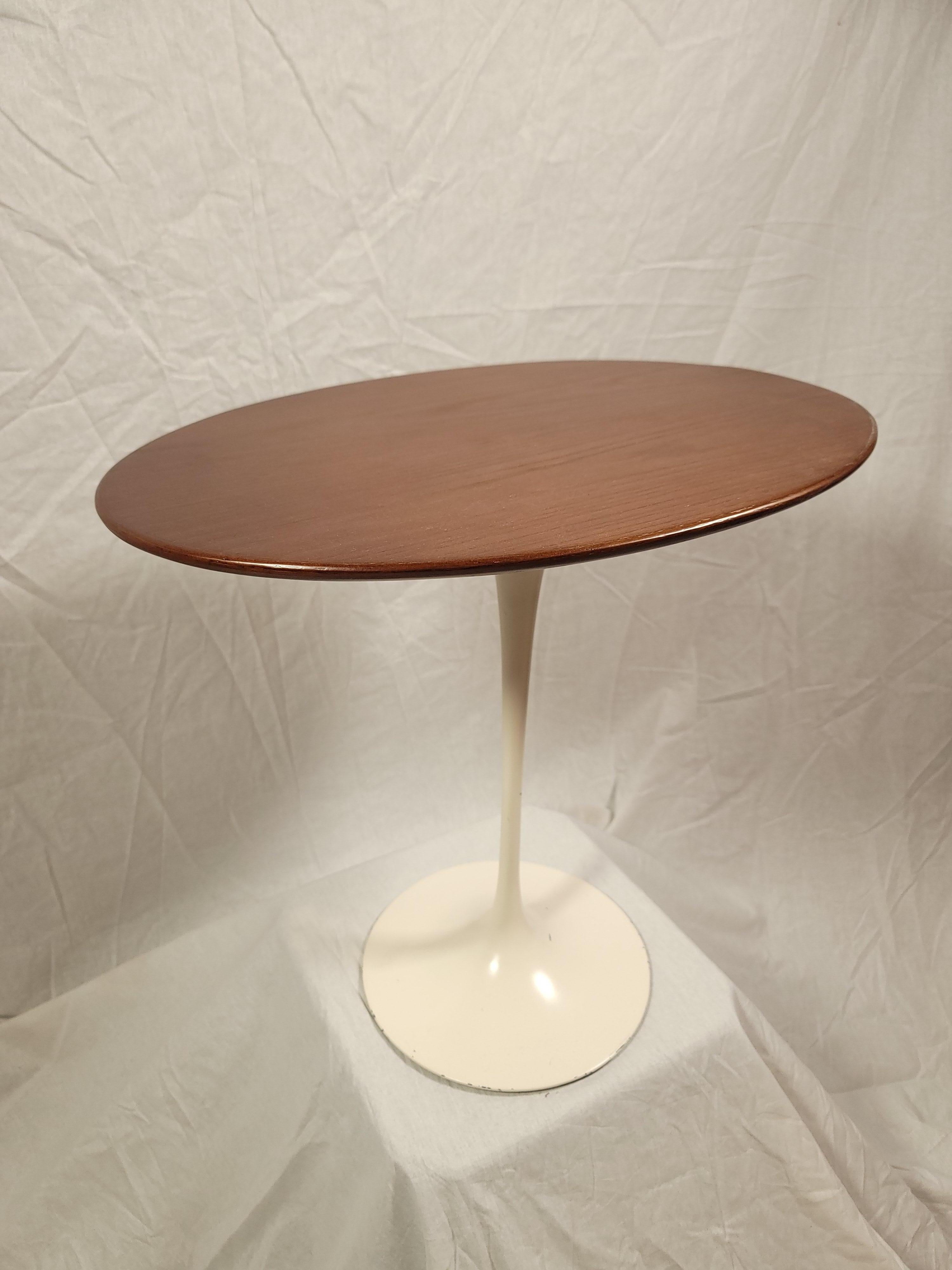 This Eero Saarinen Tulip Base side table was designed in 1957 and manufactured in 1978, delivered to a stationary store in Houston Texas based on the original label on the underside of the top.  At some point in it's life someone accidentally