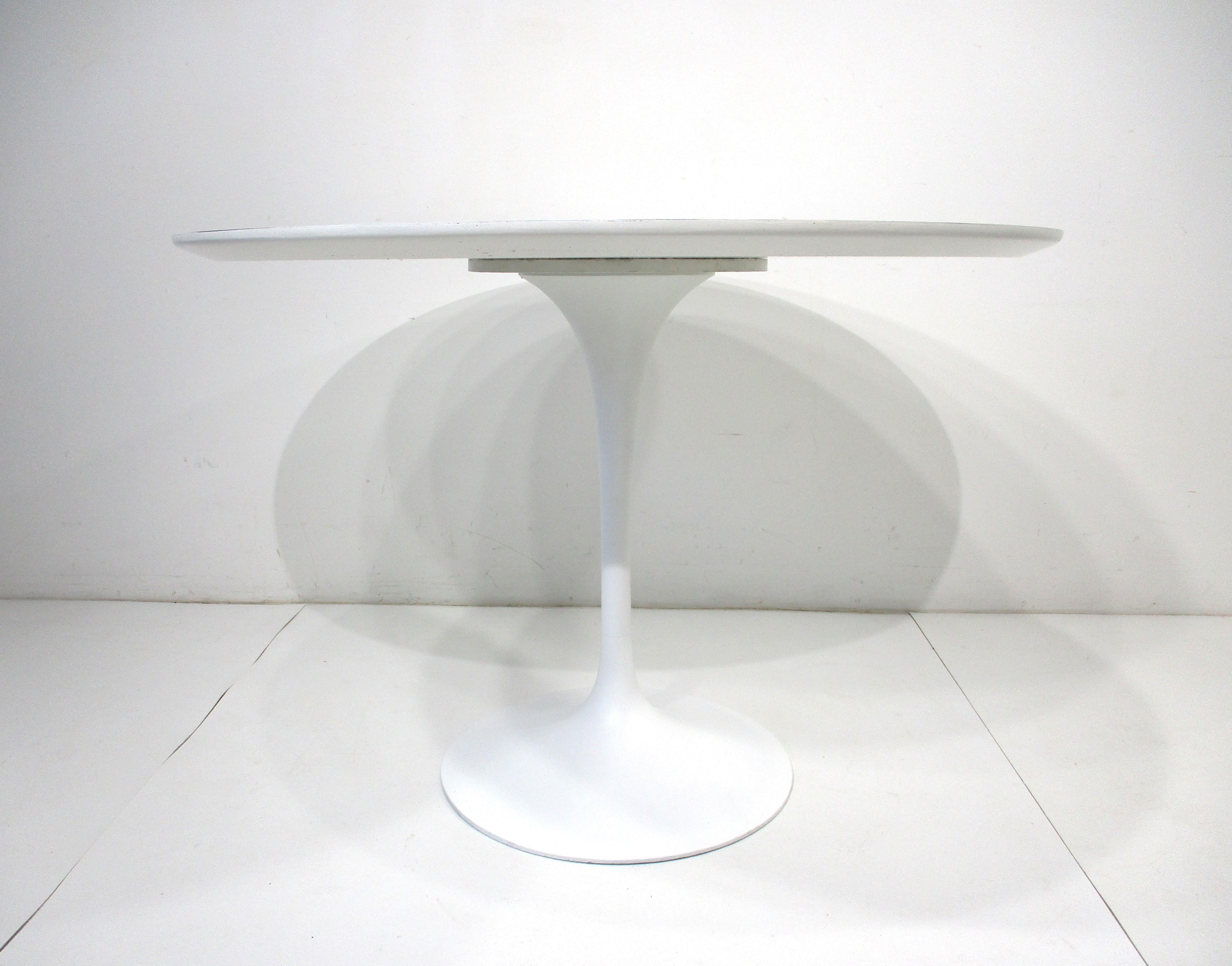 A iconic white tulip dining table in the 42