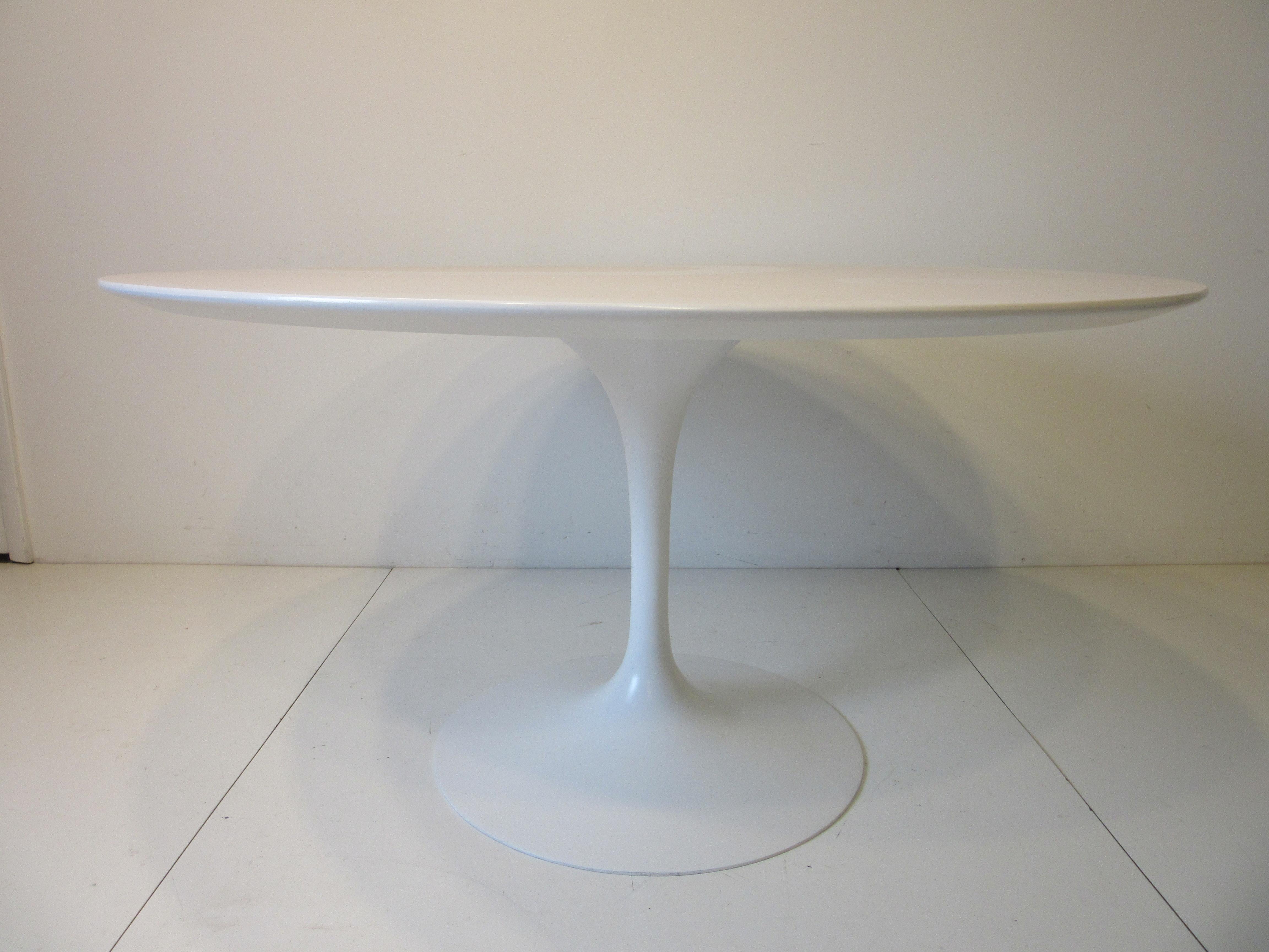 An early and larger sized tulip dining table measuring 54