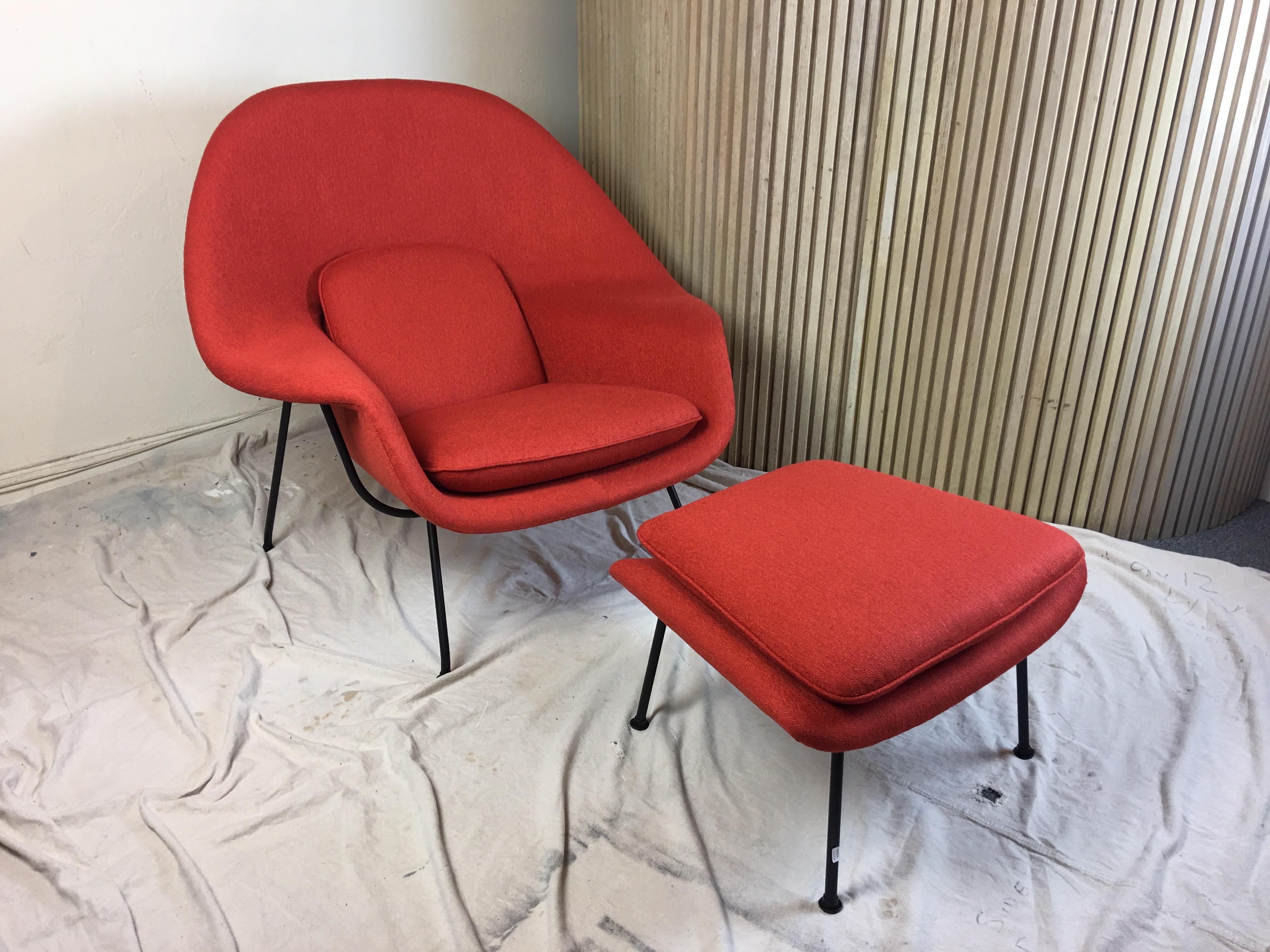 Nice early example from 1950s, cap style feet model. Newly upholstered in a red nubby weave fabric. Fiberglass body with metal frame work and legs. Said to comfort comparable to a Mother's Womb. In all honesty I think it is the most comfortable