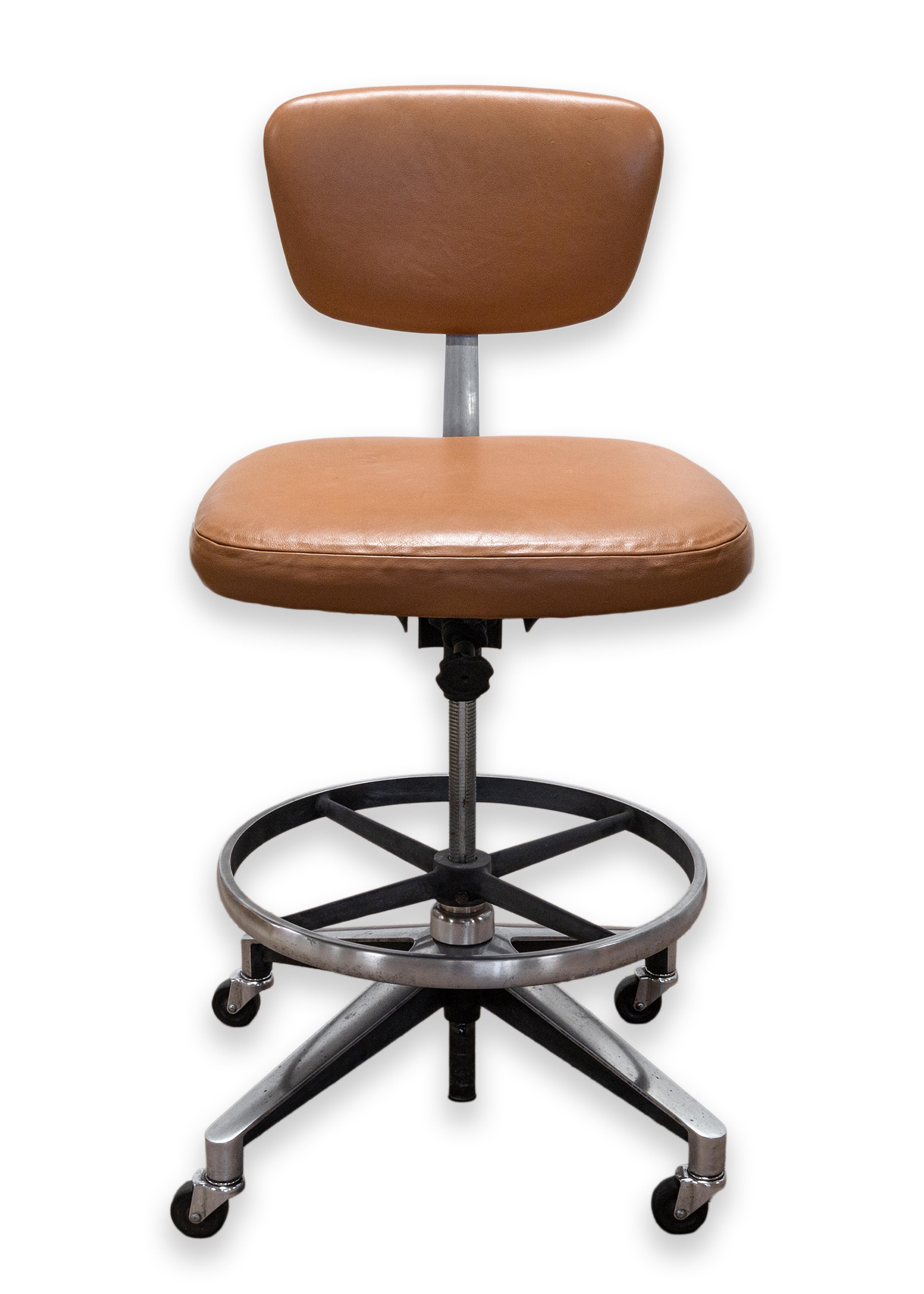  A rare drafting stool designed by renowned architect and designer Eero Saarinen for Knoll, 1956. Model 77 S of the 70 series. Original light brown leather upholstery with a chrome pedestal, x-form base, and circular footrest. An adjustable seat for
