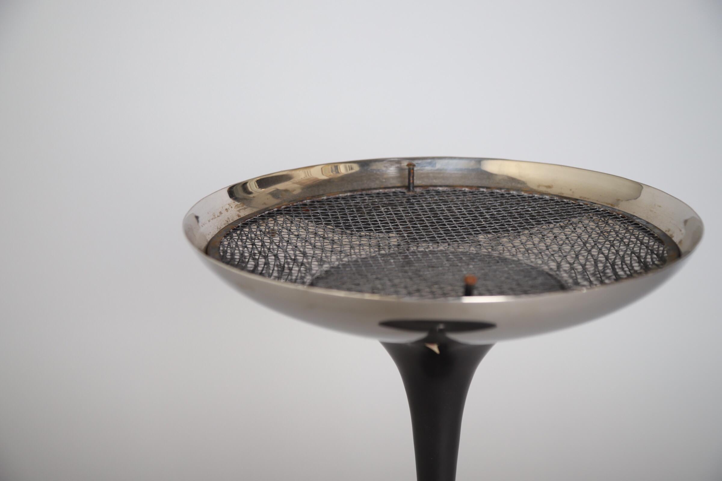 Smoke it if you got it. 

Ashtray designed by Eero Saarinen for Knoll International. Tray is in great shape with a wonderful shine. The black base shows some scratches but nothing major. Screen has both feet and is completely intact. Add sand and