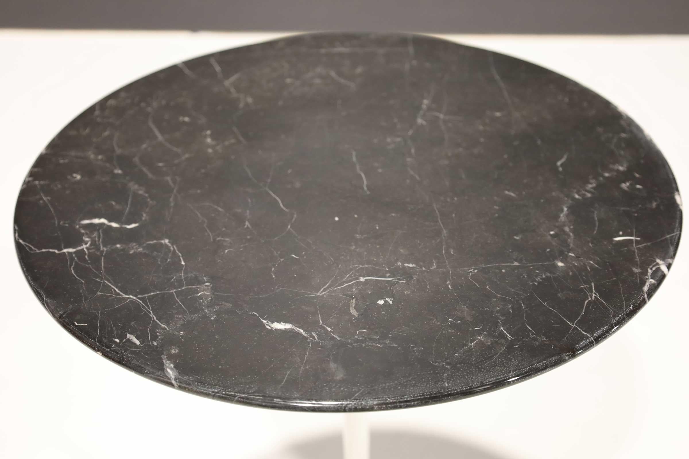 Classic Knoll tulip side table in Nero Maquina marble top with white base.