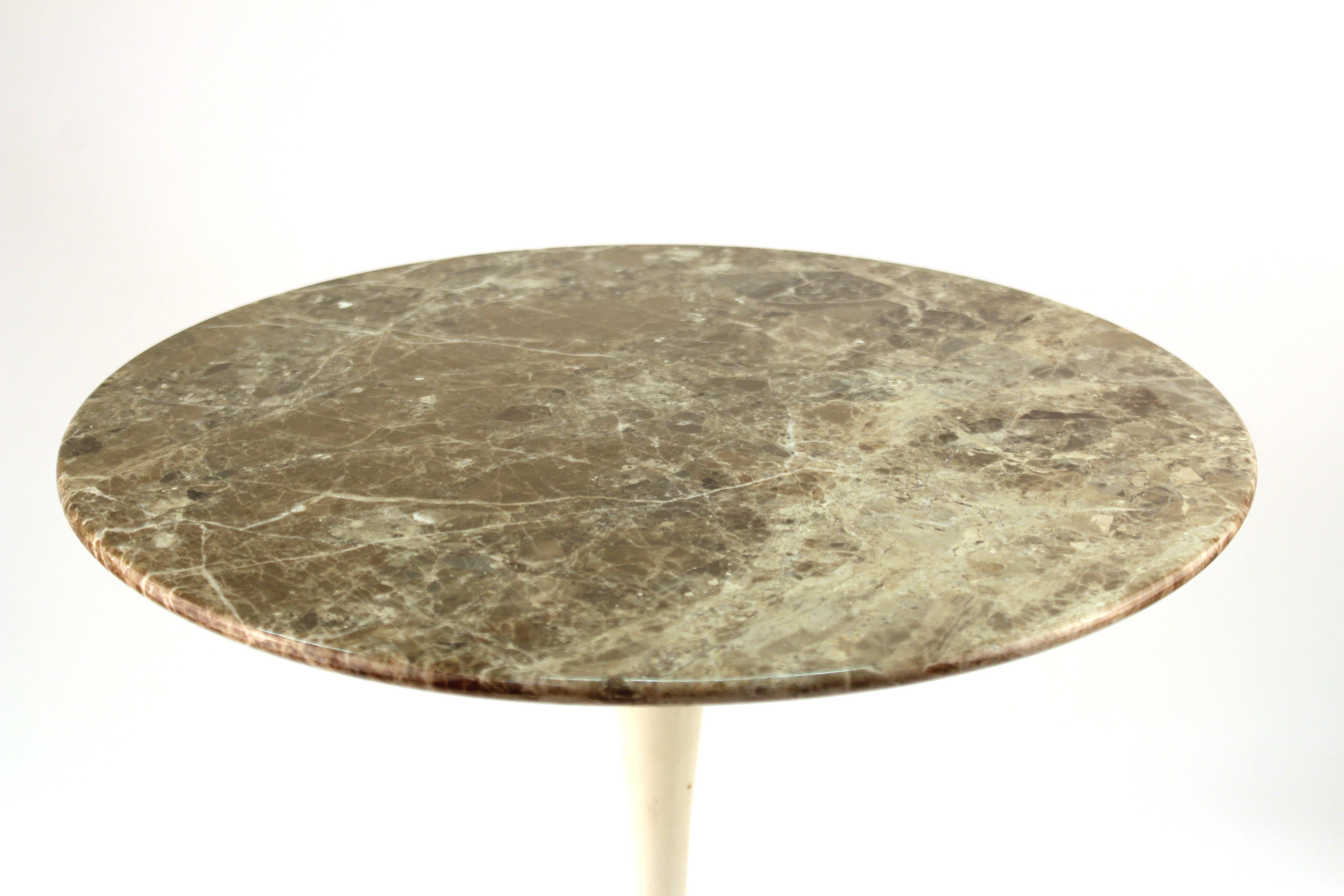 American Mid-Century Modern Tulip side table designed by Eero Saarinen for Knoll International in the mid-20th century. From the estate of the late Peter Knoll in New York City. The piece has a natural marble top and cast iron base. In good vintage