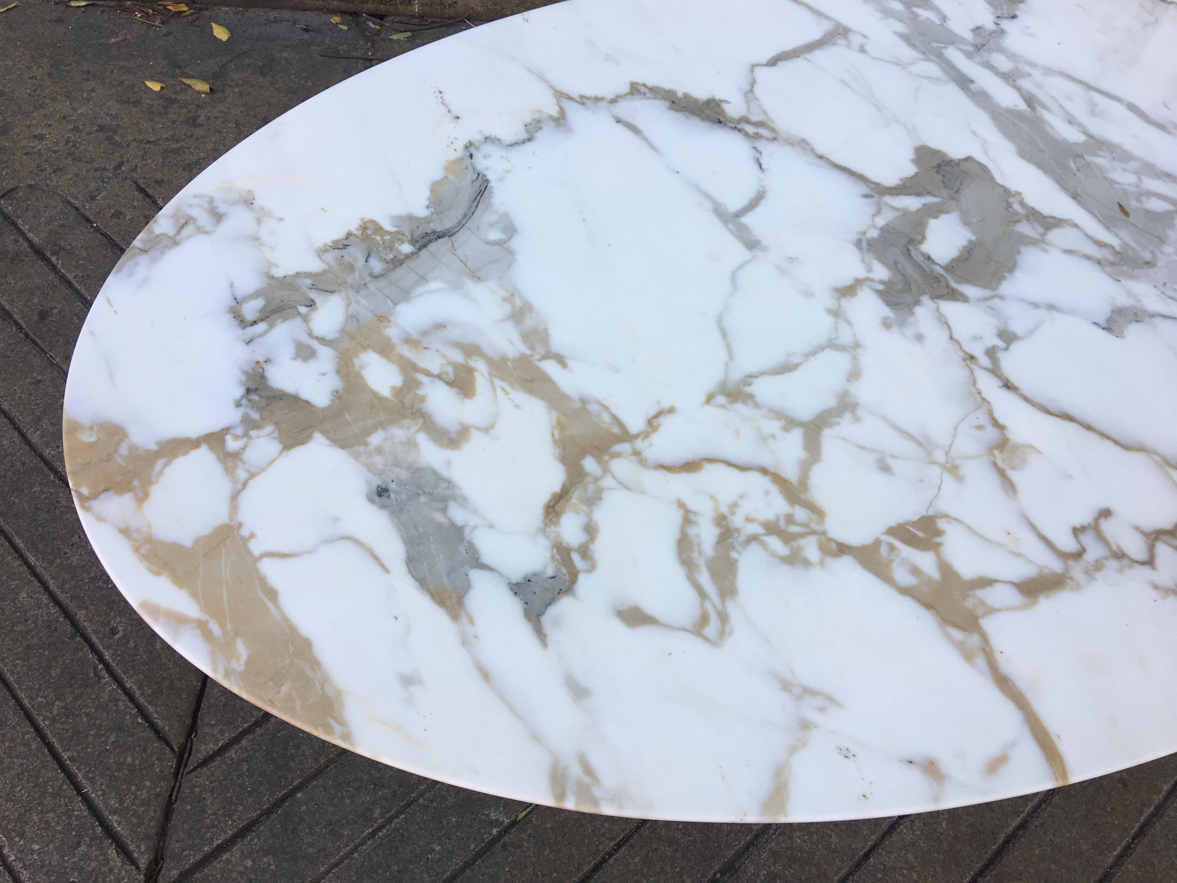 Eero Saarinen for Knoll marble coffee table with older cast iron base. Bought from original owner. Beautiful grained white marble with hints of light brown evenly mottled.
