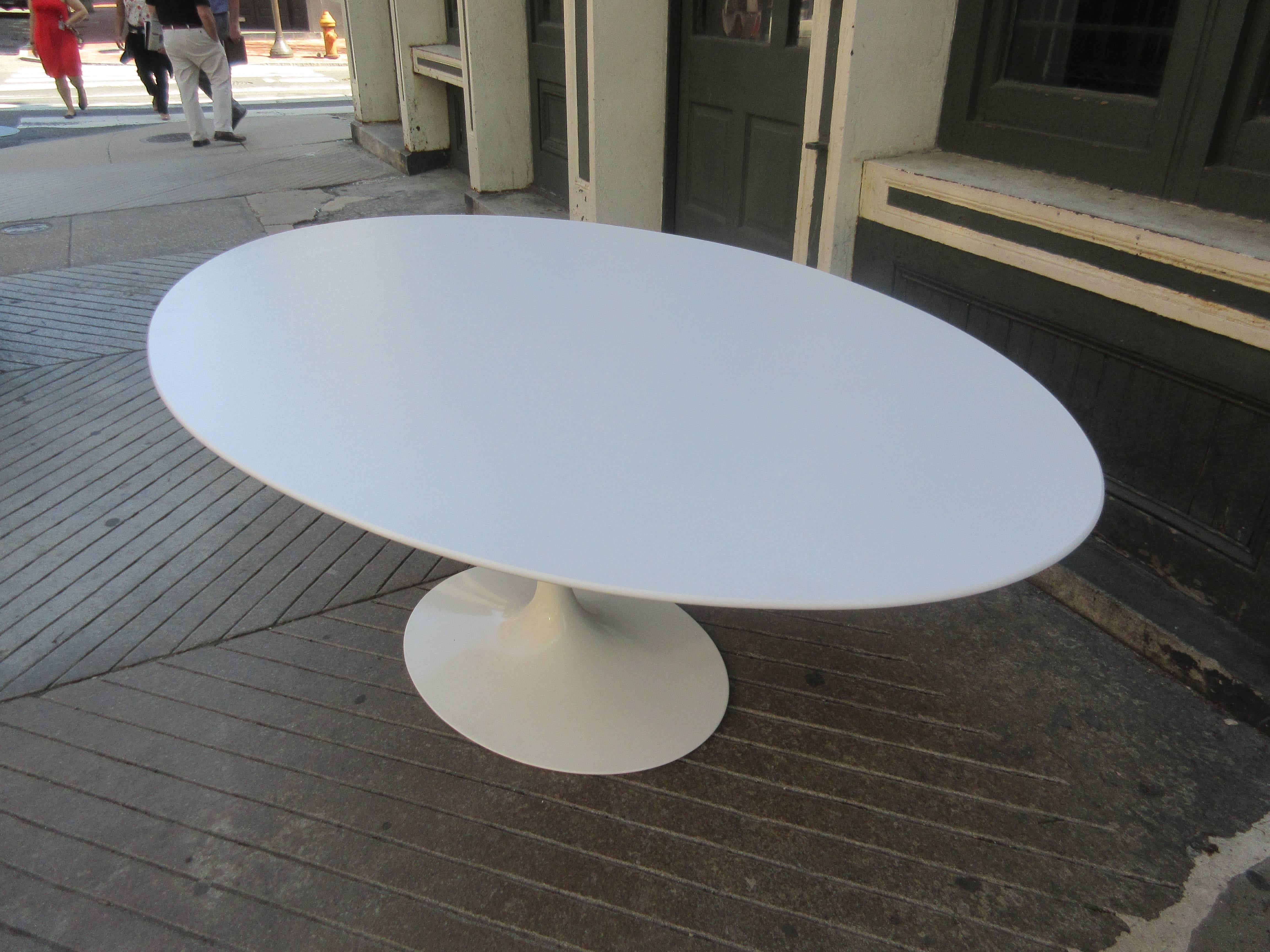 Eero Saarinen for Knoll 78 inch oval tulip table. Table retains all labels and is dated a 2013 production. Pure white laminate top and base in mint condition.