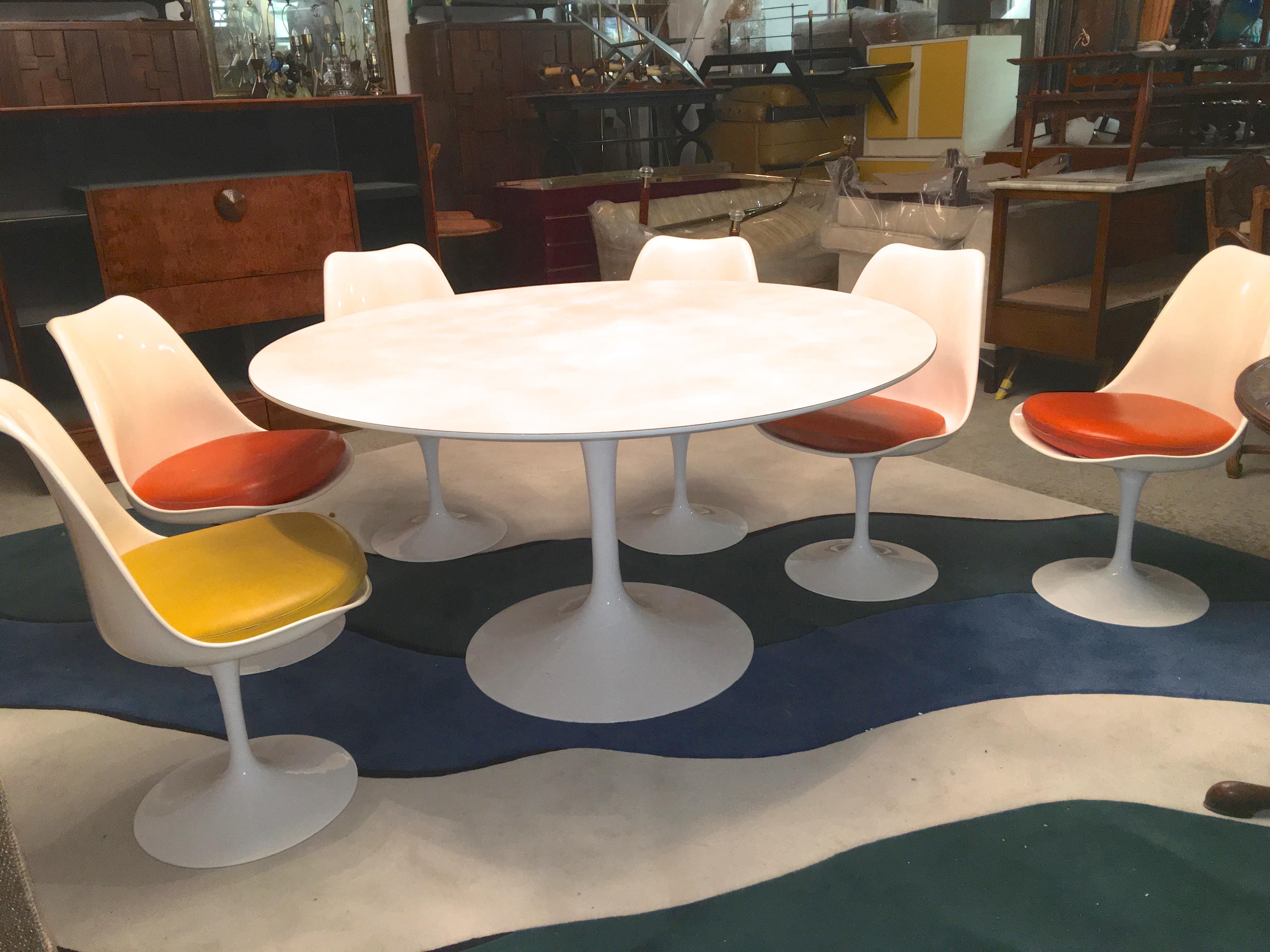 Restored vintage early 1960s Knoll production Eero Saarinen Tulip 54 inch diameter round white laminate tabletop. (Chairs are no longer available)
The cast aluminum tulip base of the table has been newly powder coated in high gloss white and looks