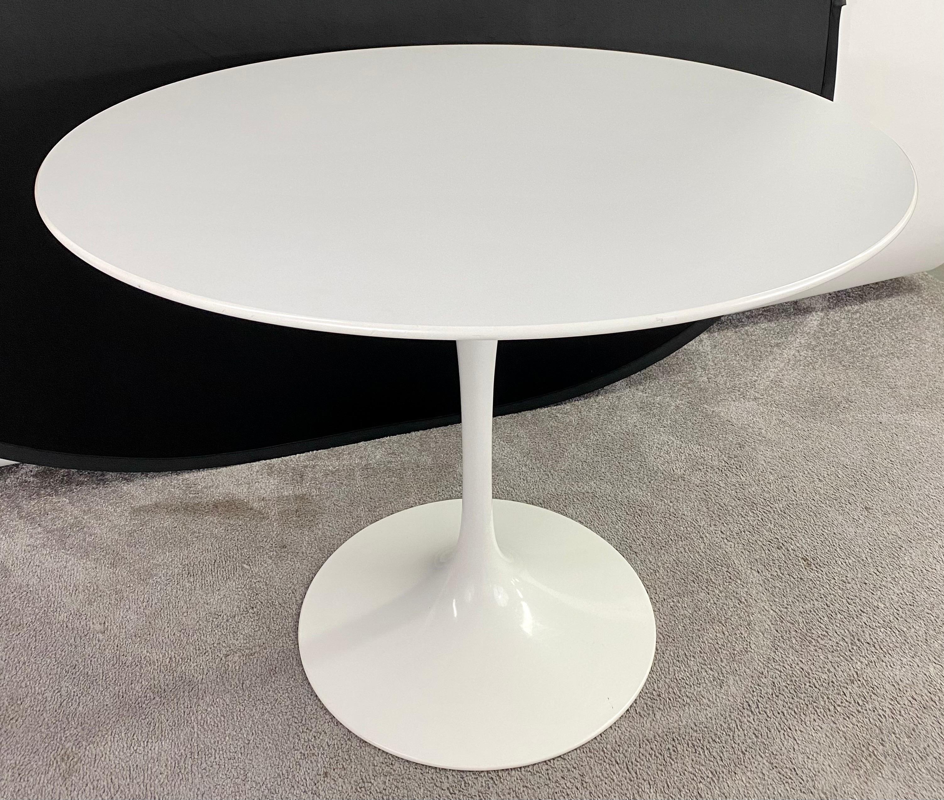 The Eero Saarinen (American / Finish 1910 - 1961) Mid-Century Modern white tulip pedestal dining or center table is one of the most iconic MCM design pieces. The table was designed for and manufactured by the quality house Knoll Studios. Elegant and