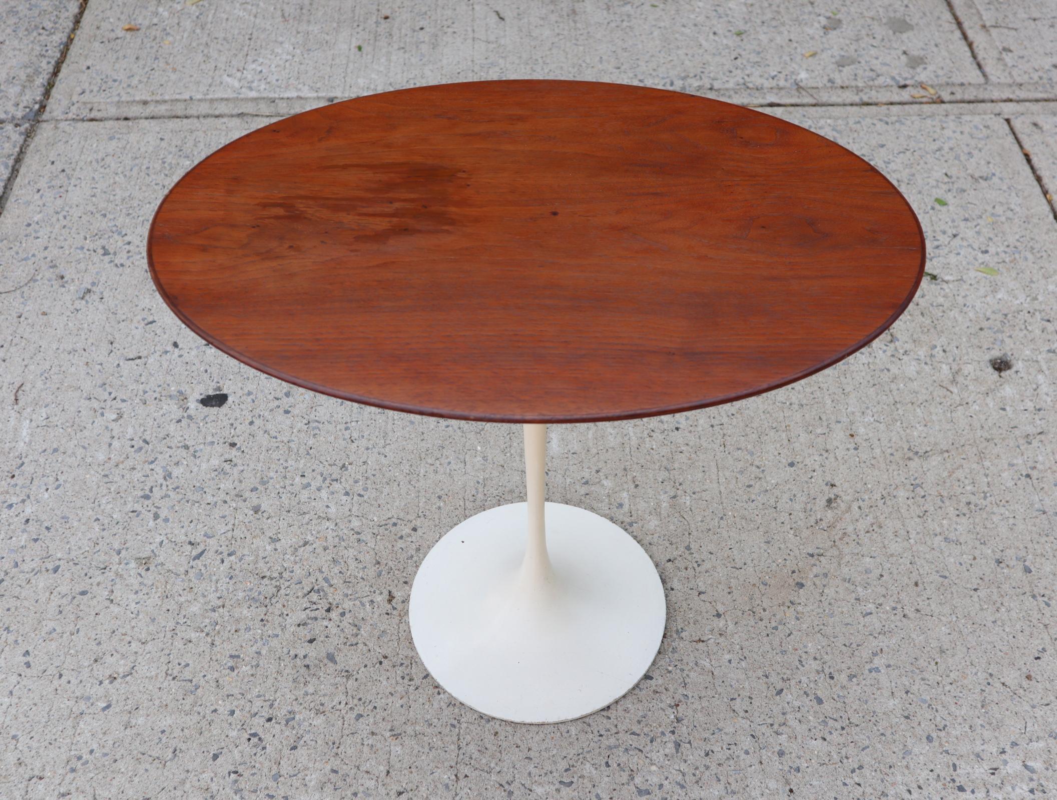 Vintage walnut side table designed by Eero Saarinen for Knoll. Lovey elliptical contours differentiate this design from the more common circular tops. Base with original finish, top has been touched up. Acquired from the original owner who purchased