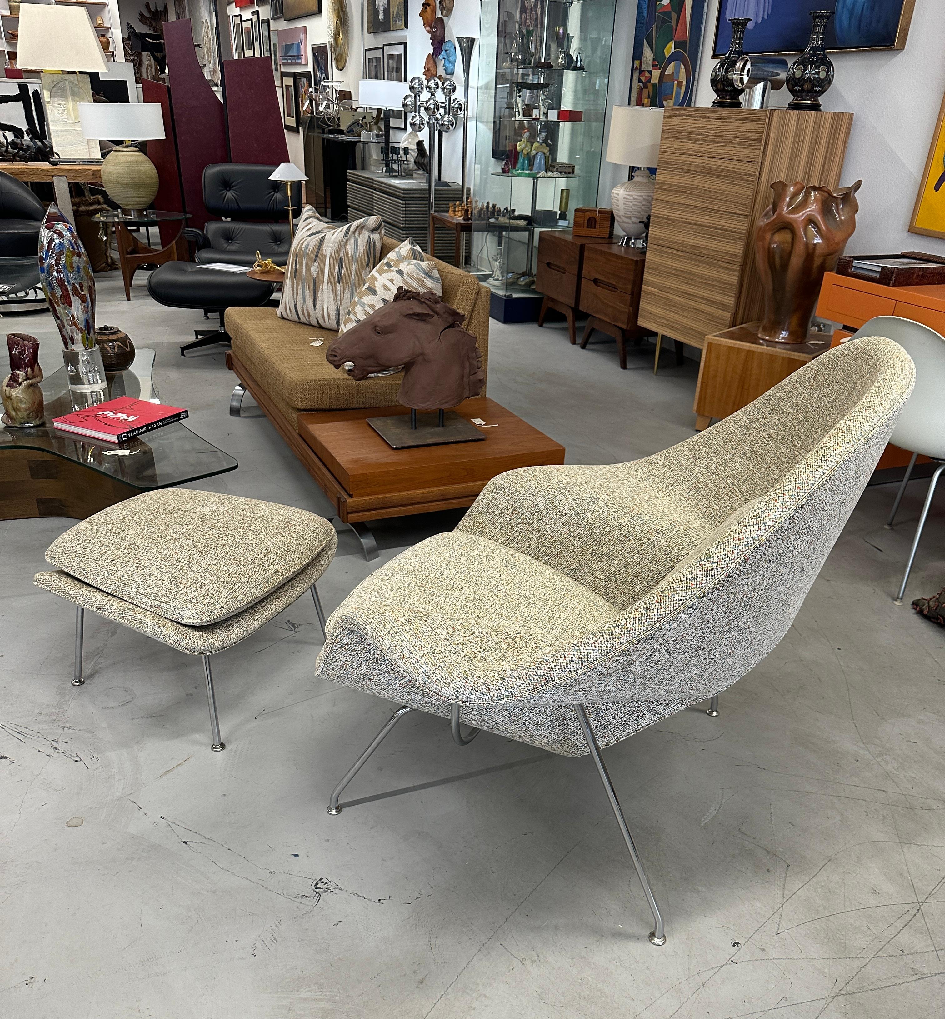 A beautiful Eero Saarinen designed Womb chair and ottoman for Knoll. Late 20th century vintage. Not sure of the fabric name but it is a nubby fabric with subtle tones of orange, turquoise and green on a cream base. The legs are chromed steel. Both