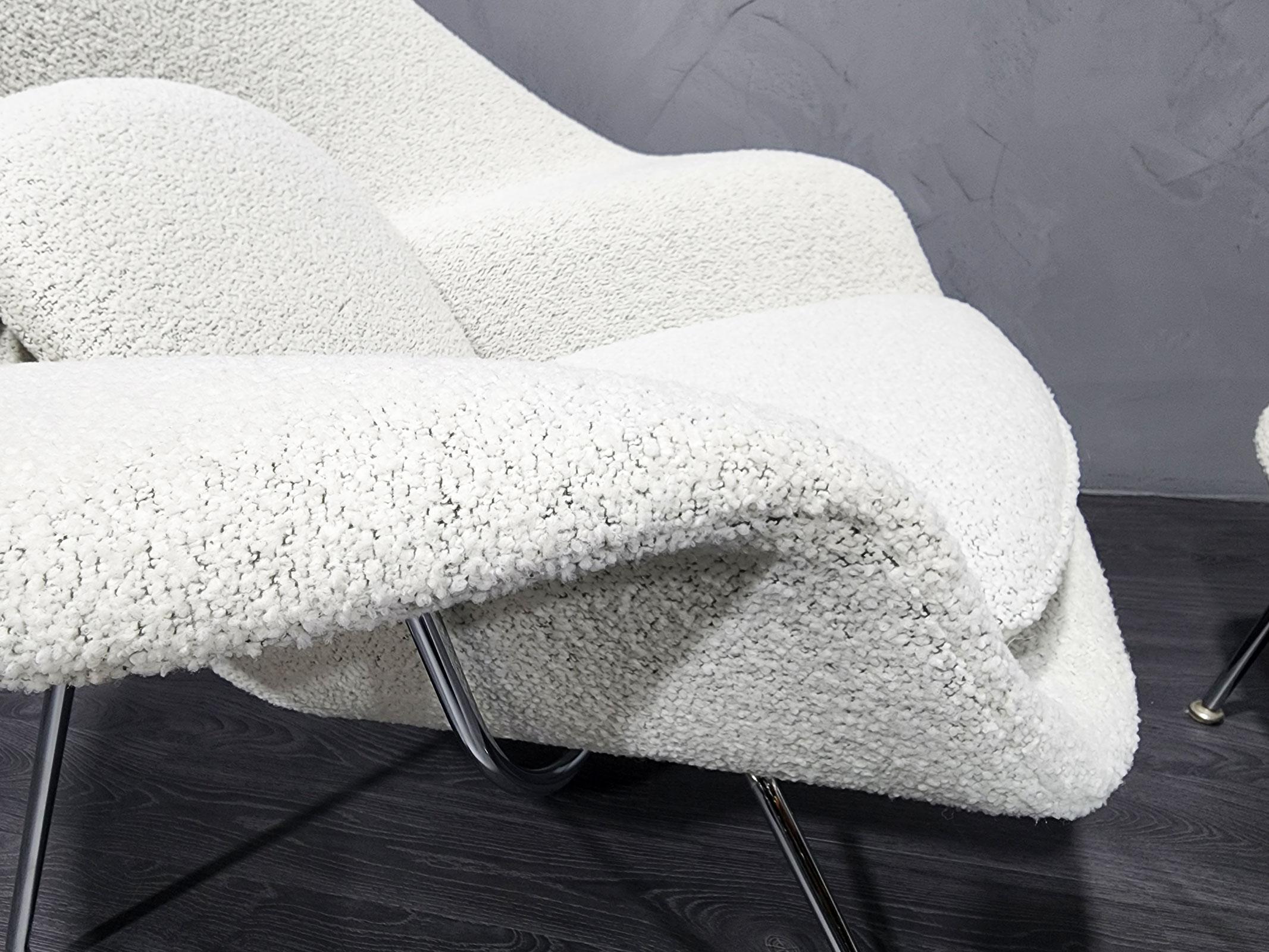 Eero Saarinen's iconic womb chair with ottoman. We have restored this 20th Century chair with a beautiful high-quality off-white boucle with a black undertone. Super soft and this chair in amazingly comfortable. A one-of-a-kind as we restore with