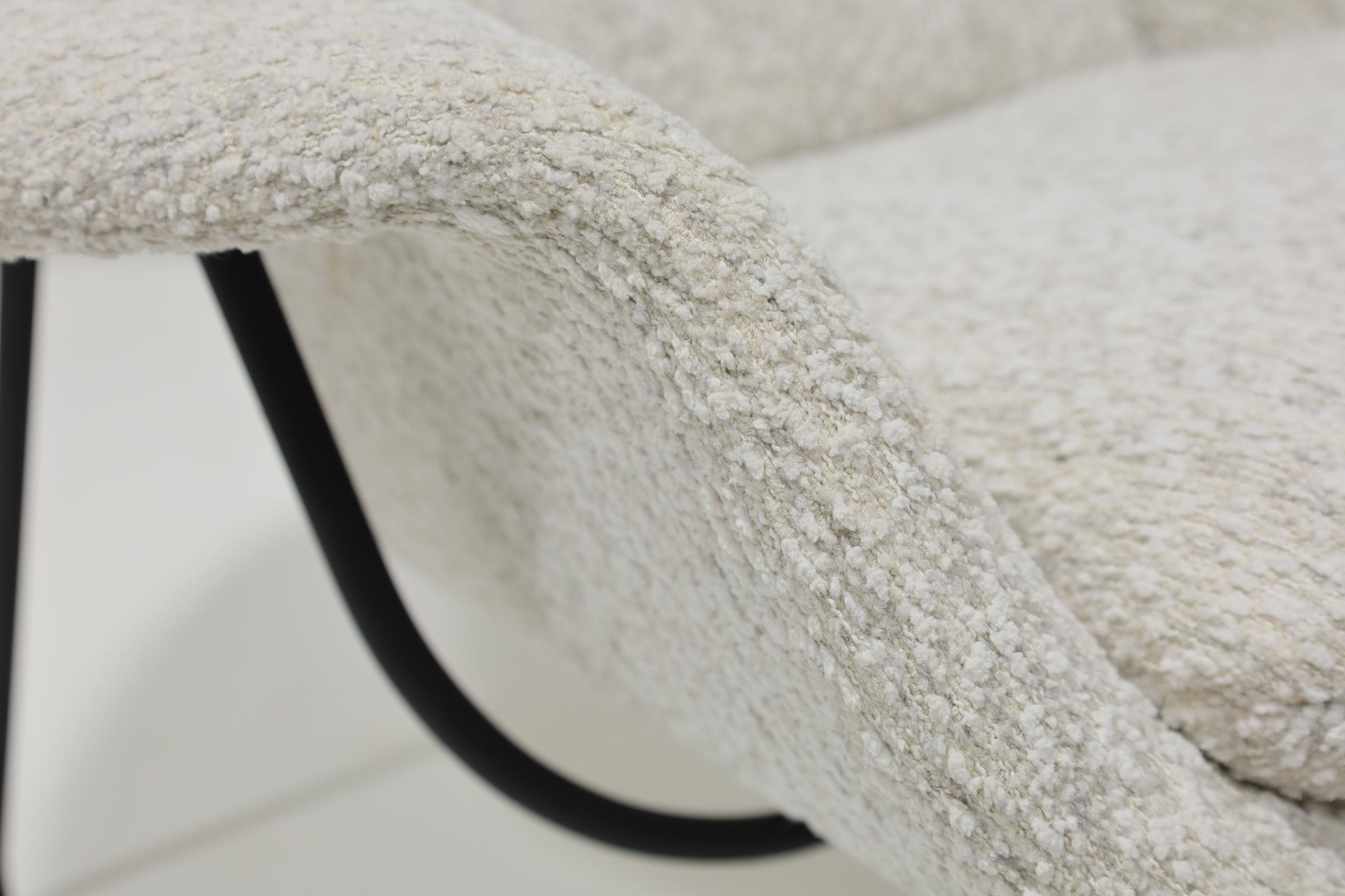 The iconic Eero Saarinen for Knoll Womb Chair, newly upholstered in an exquisite bouclé with black frame. 