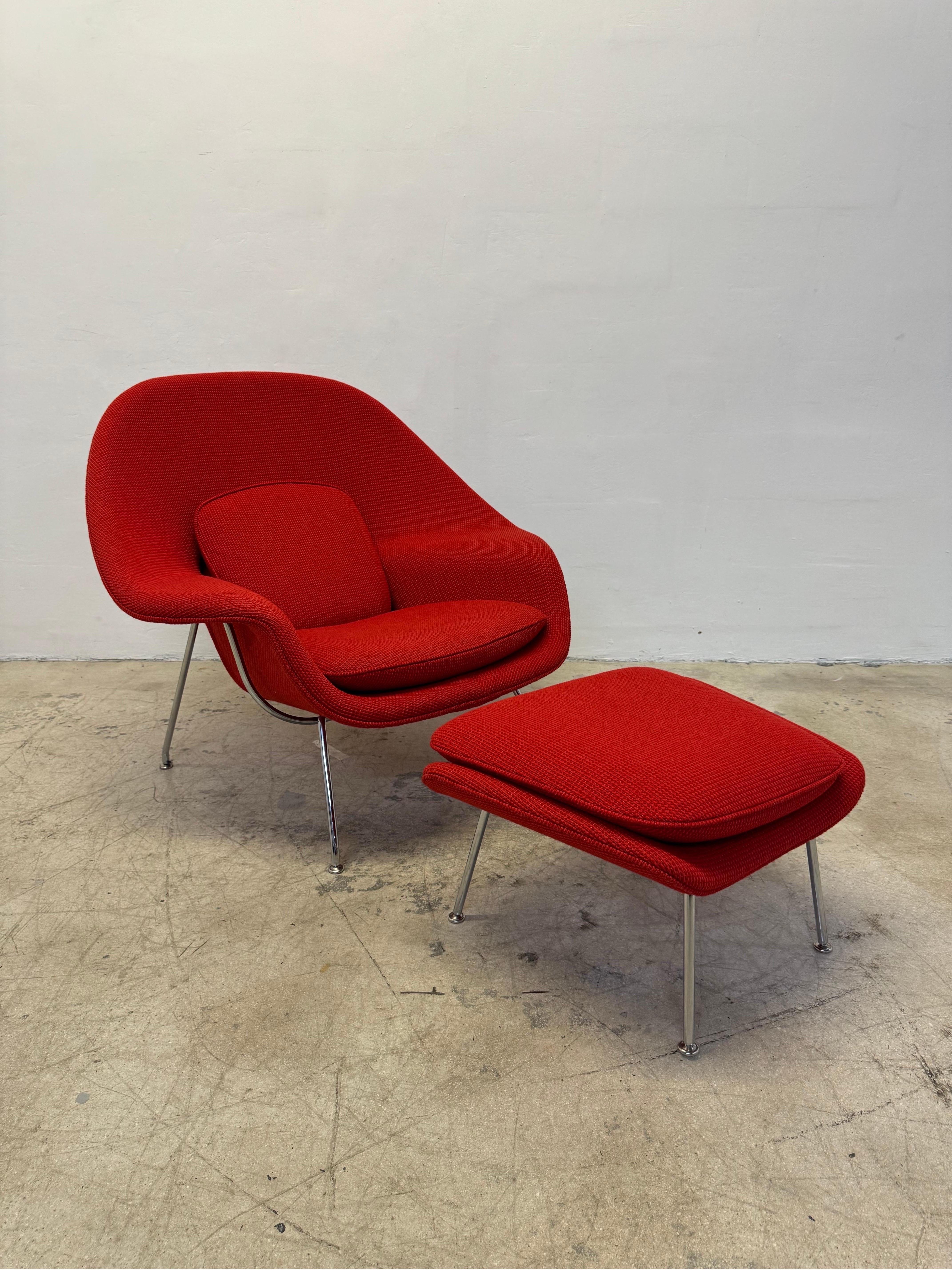 Original Eero Saarinen Womb lounge chair and ottoman covered in Cato - Fire Red Knoll fabric with tubular chrome legs.  Eero Sarrinen designed this piece for Knoll in 1948 and this model was produced late 2020s. Fabric is in excellent, showroom