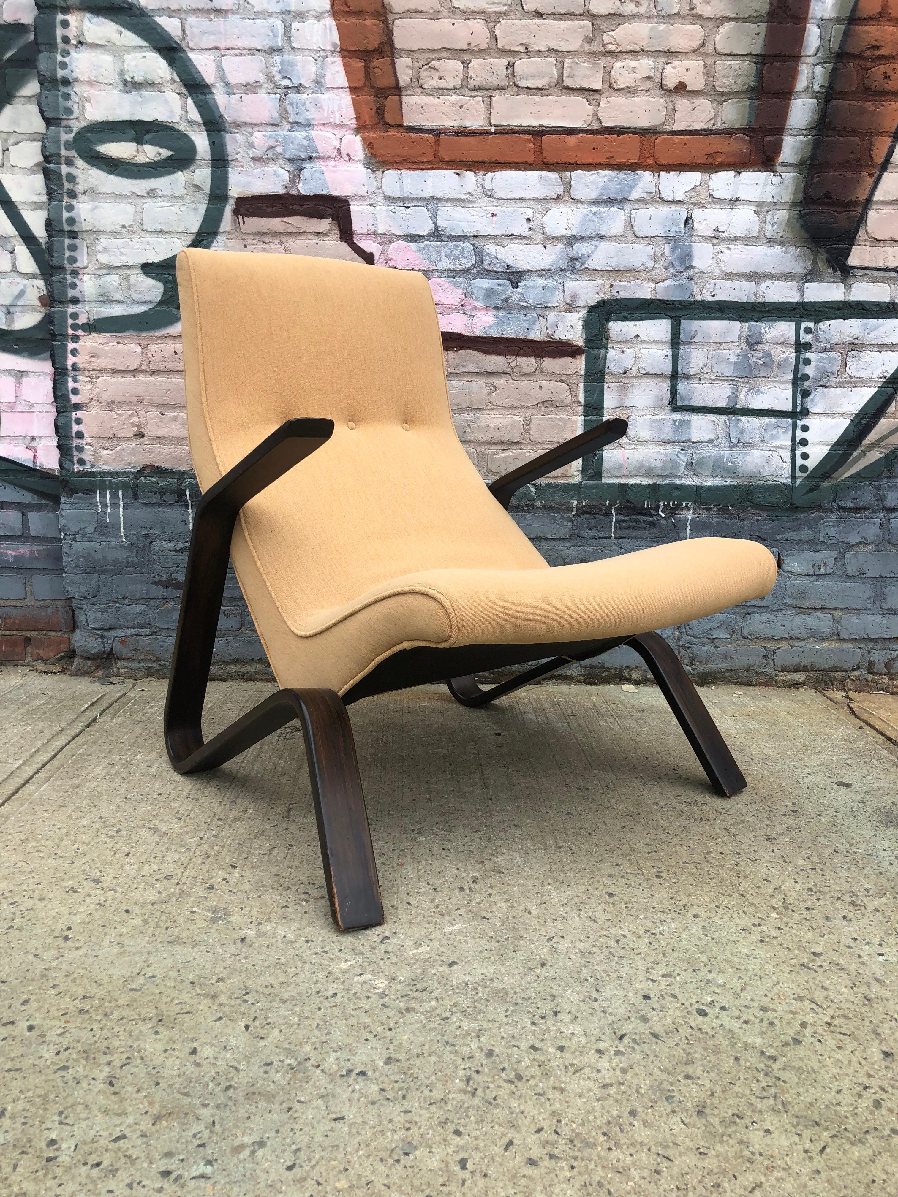 Extremely comfortable and elegant Eero Saarinen grasshopper chair and ottoman. In good condition with original chair and ottoman set. No tears or burns to upholstery. Original wood finish.