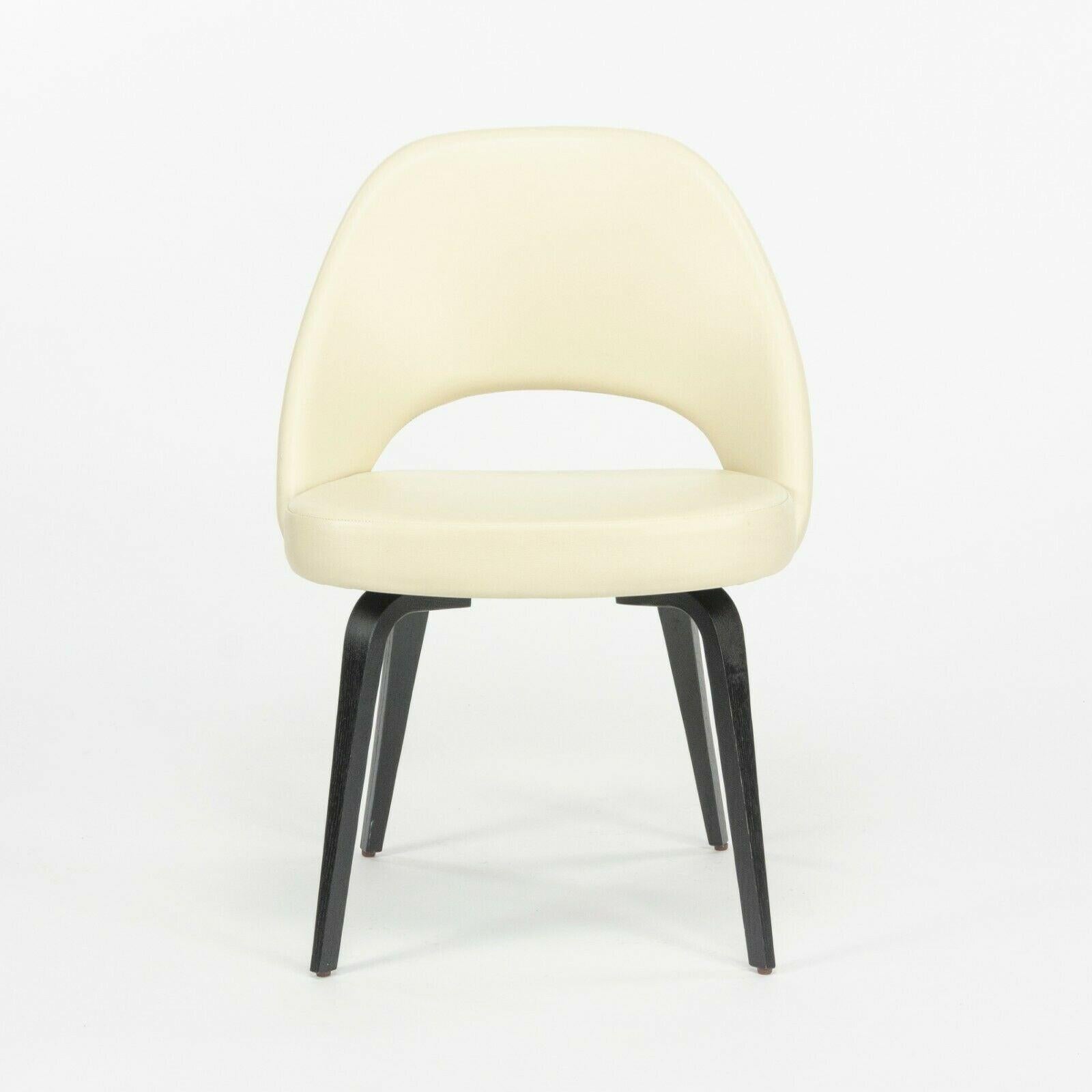 Listed for sale is a single (two are available for sale) 2020 production Eero Saarinen for Knoll Executive side chair with ivory leather and ebonized walnut wooden legs. This appears to be Knoll's Volo leather, which is ivory/off-white in color. It