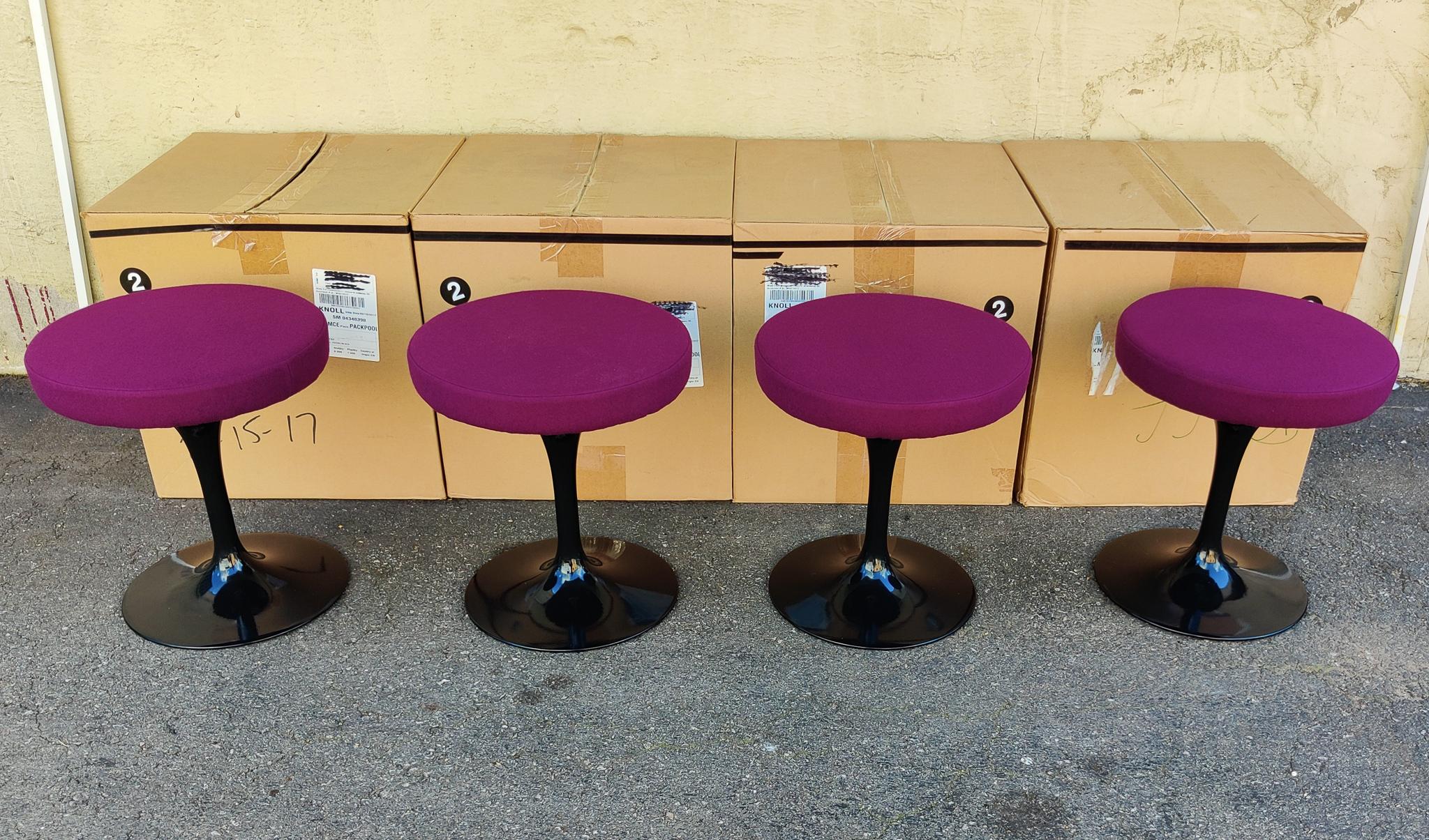 New in the box, one (1) Eero Saarinen - KnollStudio swivel-seat Tulip stool. Hourglass form in purple upholstered seat and black plastic coated aluminum base.  Each stool is new in the box, never used. Excellent condition. Complete with original