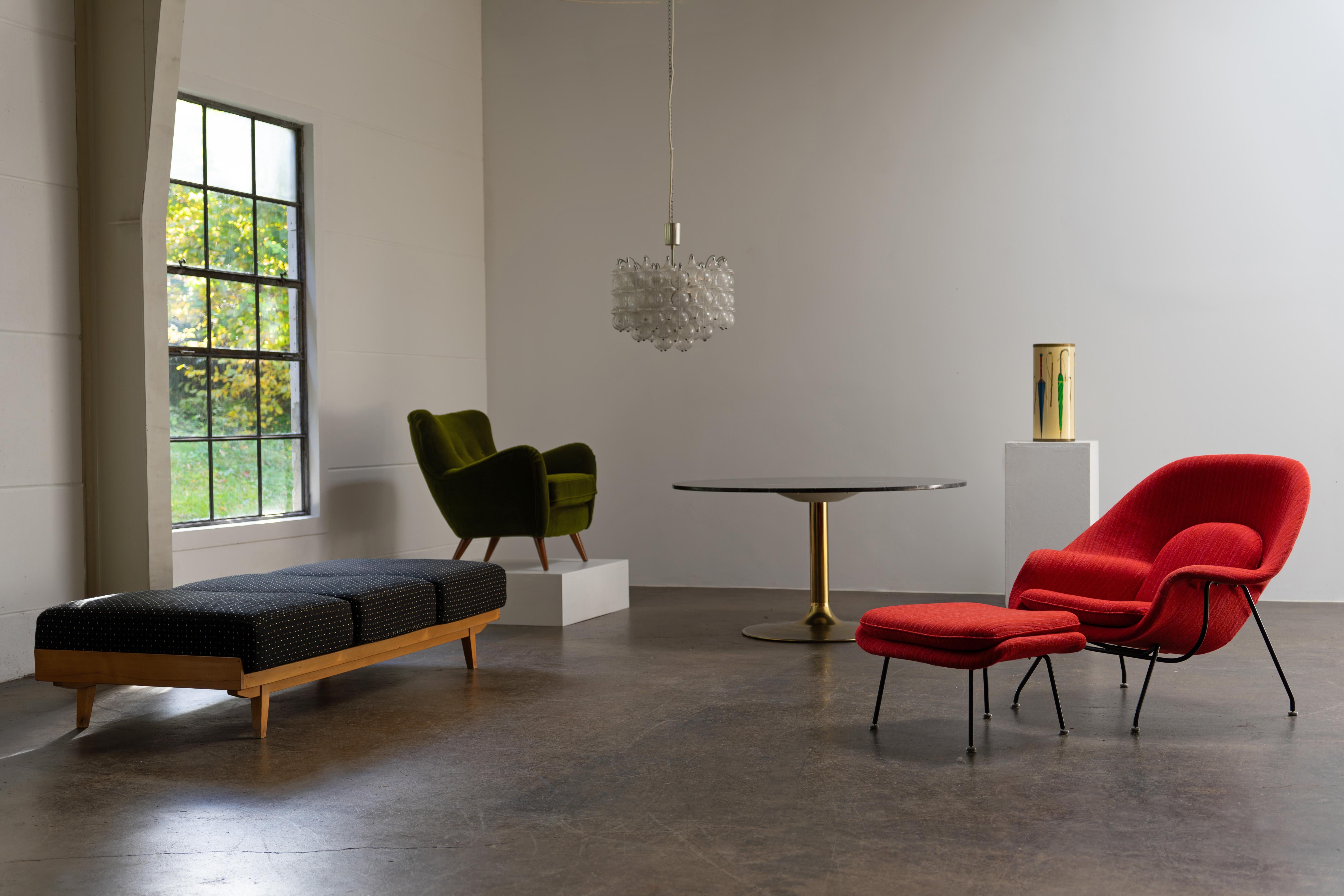 Womb Lounge Chair with ottoman by Knoll International, designed by Eero Saarinen and produced in the 1960s. This iconic chair is renowned for its organic shapes and unparalleled comfort, enhanced by generous cushioning and a wide, inviting seat. The