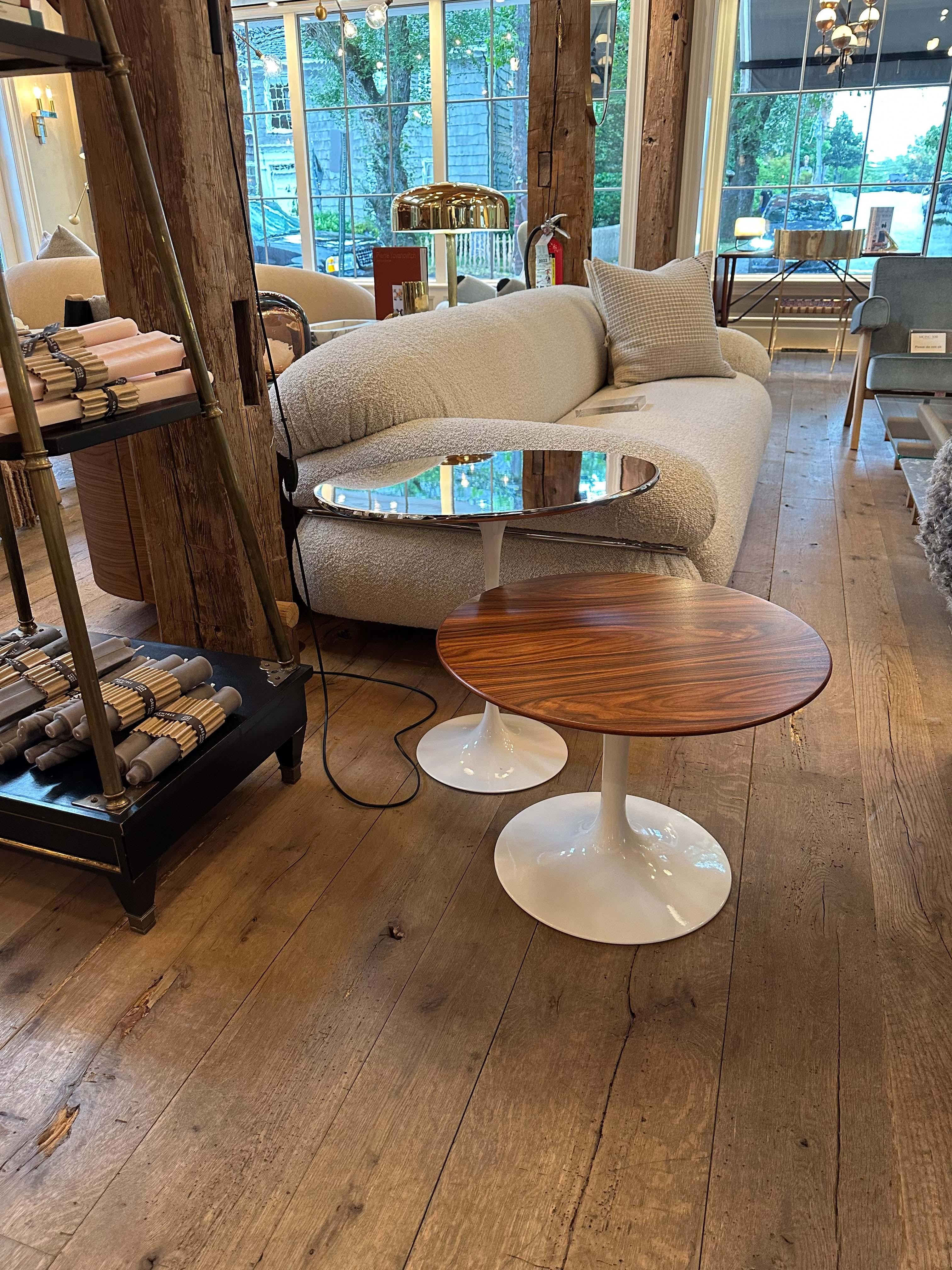 Experience timeless design with the Eero Saarinen Oval Side Table from Knoll. Featuring a seamless, organic form with a rosewood and white base, this iconic side table enhances any room's style and appeal. Expertly-crafted to highest quality