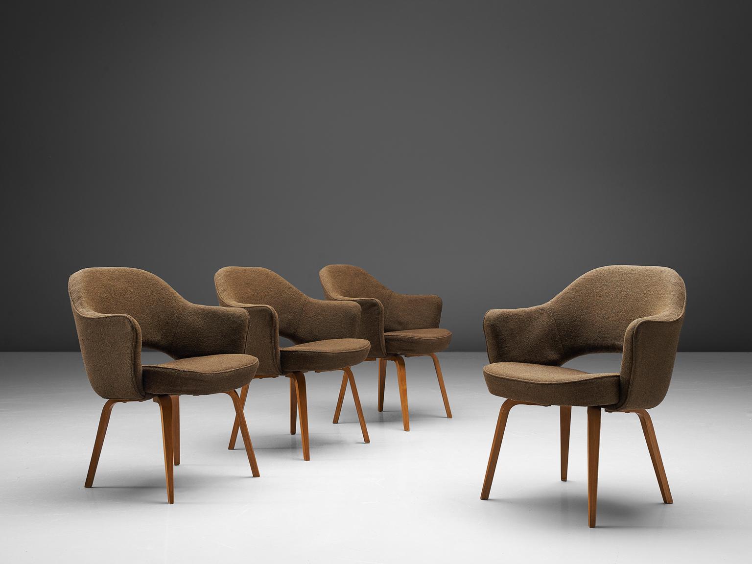 Eero Saarinen for Knoll International, set of four chairs model 71A, in wood and beige brown fabric, United States, 1948. 

Four iconic armchairs designed by Eero Saarinen. This iconic model is reupholstered in a brown grey fabric. The chairs