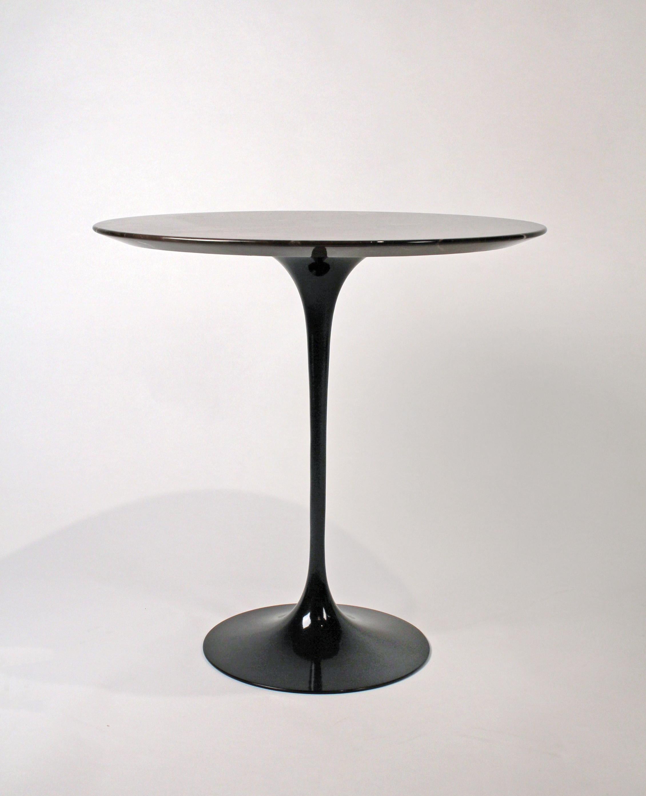Original Eero Saarinen side table manufactured with black base and polished espresso top.