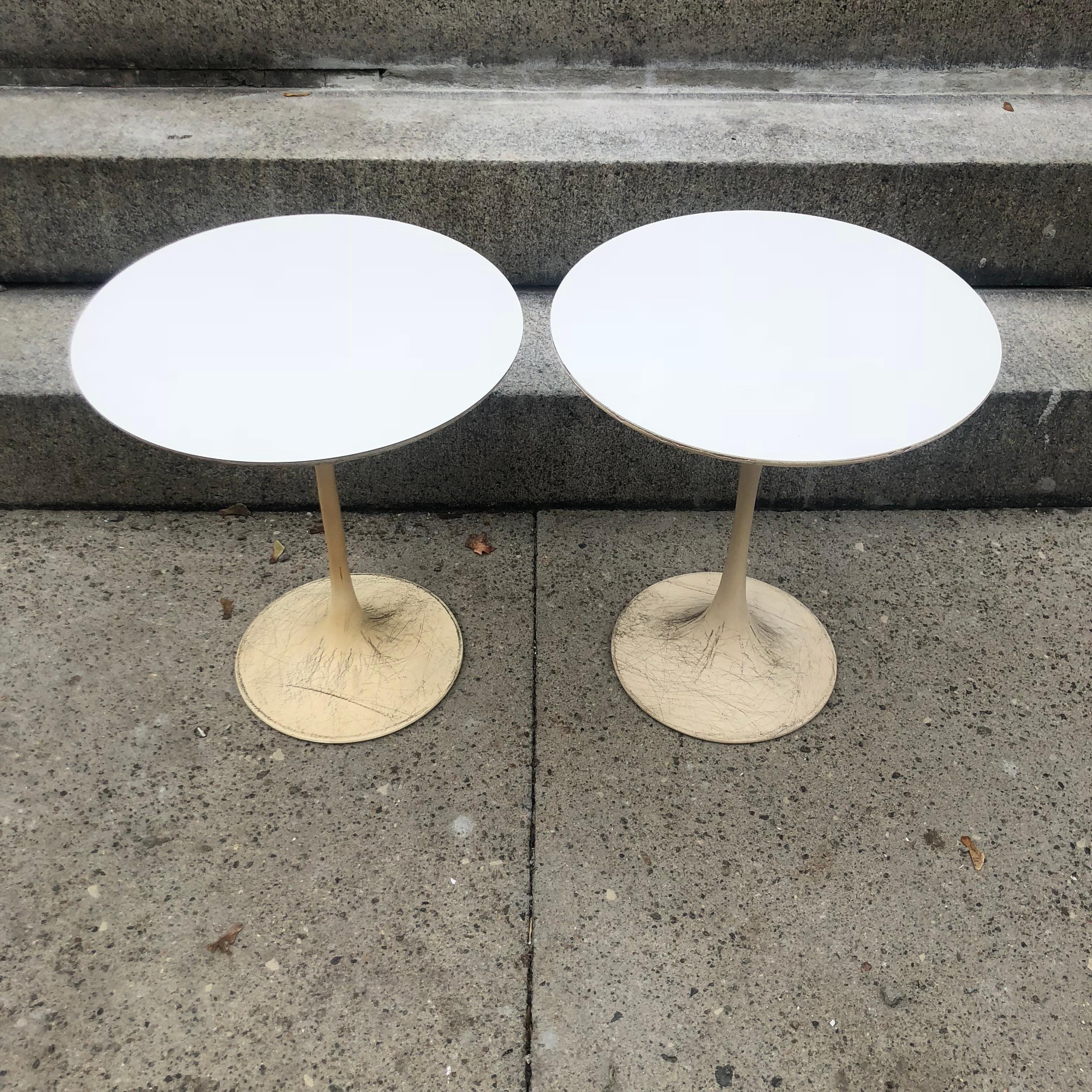 Pair of matching side tables in the style of Eero Saarinen for Knoll. We believe they are Burke. Signed BT. White laminate tops in excellent condition. Bases and underside of tops show wear and are structurally sound. Can be repainted for low cost.