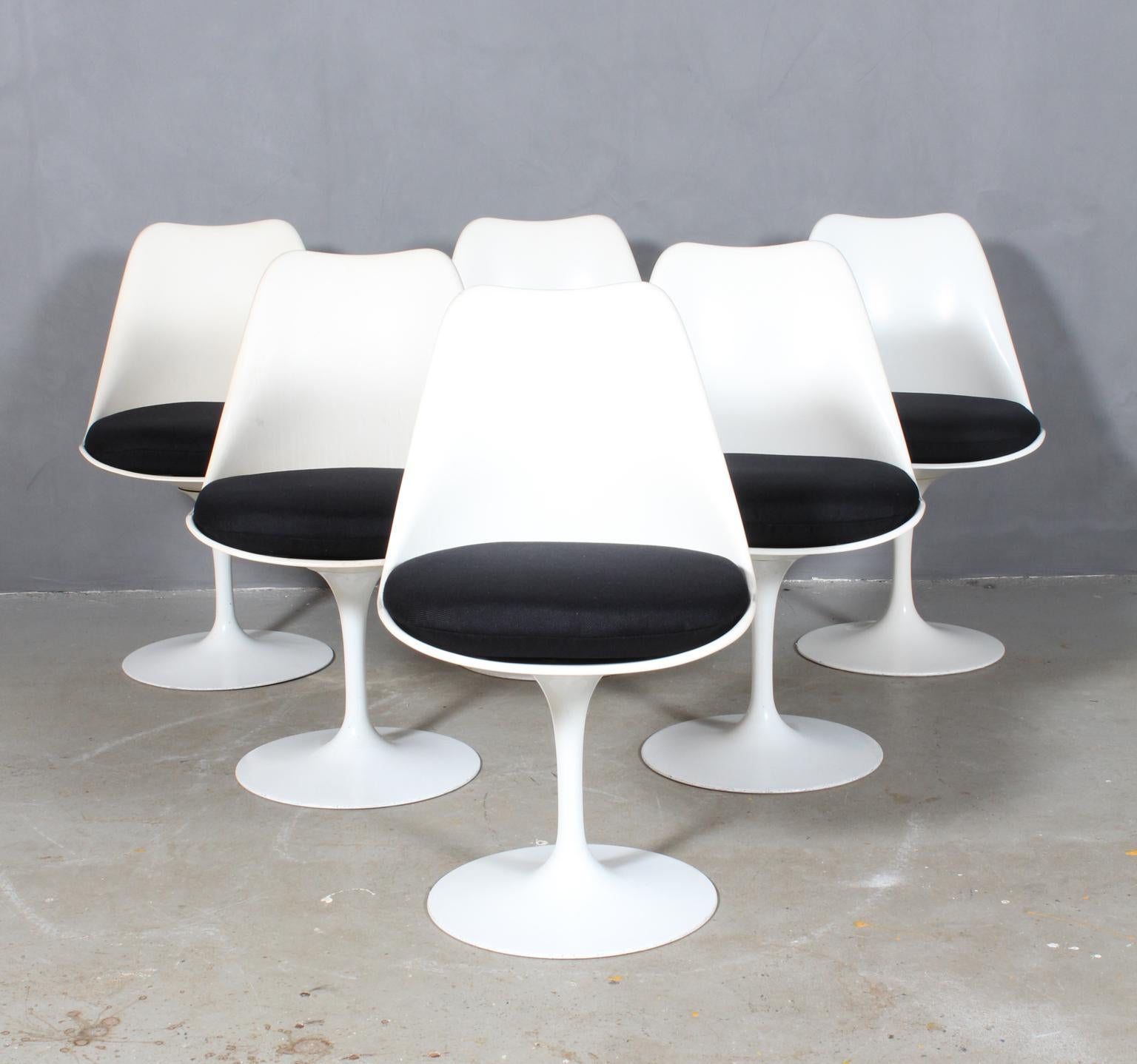 A set of six swiveling tulip chairs with new upholstered black fabric seat pads, perfect for that small eat in kitchen or cafe table manufactured by Knoll International.