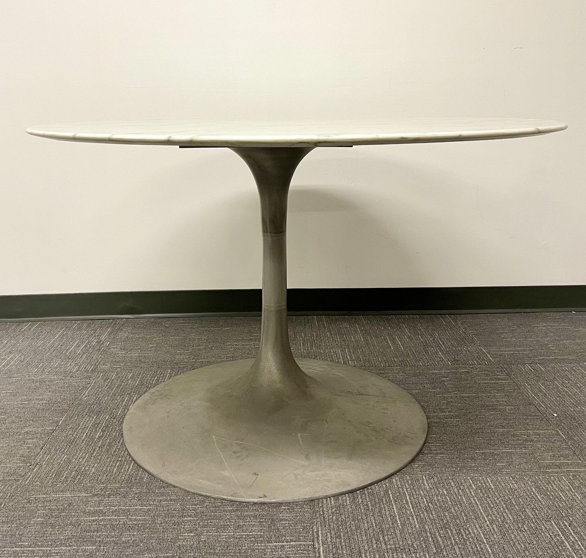 A Mid Century Modern Saarinen Style Dining or Center Table having a White Marble Top. 
 
Base is worn and dirty. In need of some polishing. Scratchs, nicks and abrasions. 
 
 August 20, 1910 – September 1, 1961) was a Finnish-American architect and