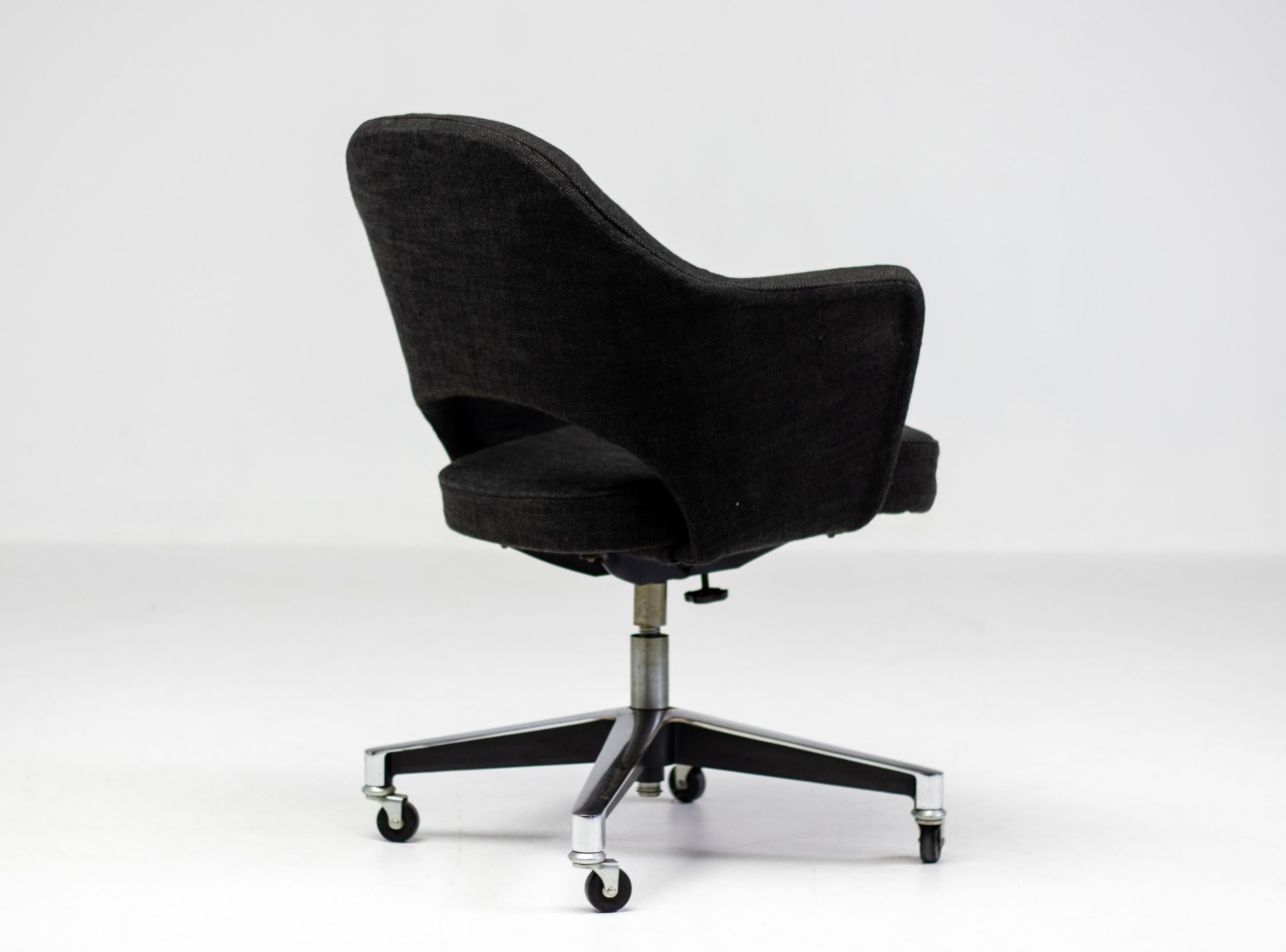Early executive arm chair with rare height adjustability, tilt and swivel.  Designed in 1950 by Eero Saarinen for Knoll International. This example from the '50's, with the earliest tilt mechanism. 
All original, fully functional, the original dark