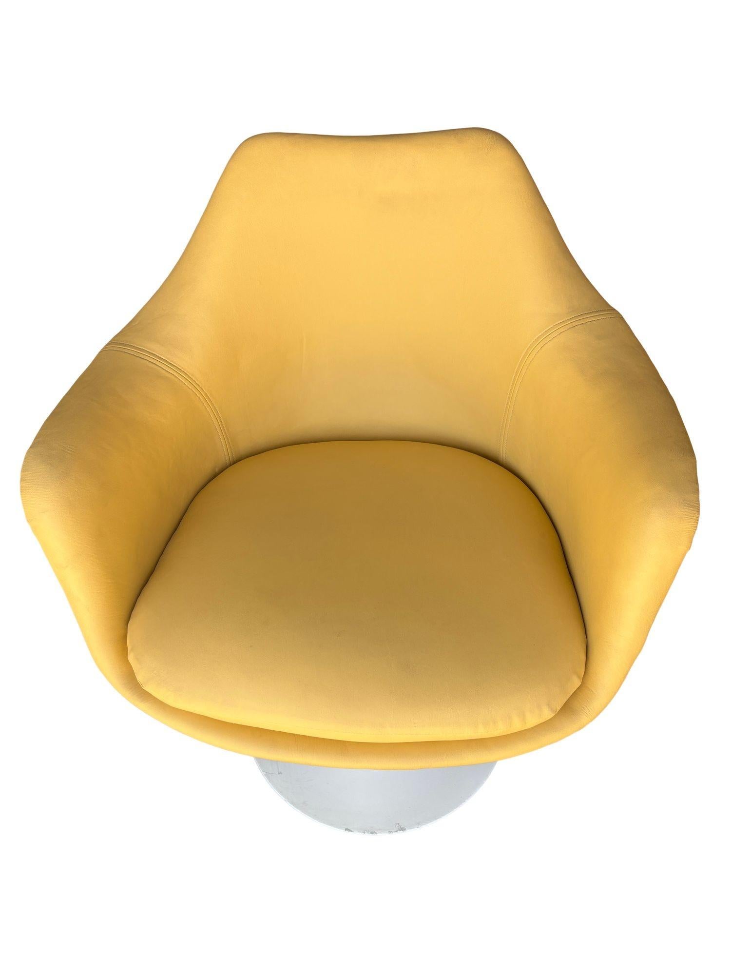 The rare Eero Saarinen Tulip Arm Chair with Upholstered Inner Shell and Seat Cushion is a striking piece from the iconic Pedestal Collection by Knoll. This particular chair features a newly reupholstered warm-toned gold leather done in-house,