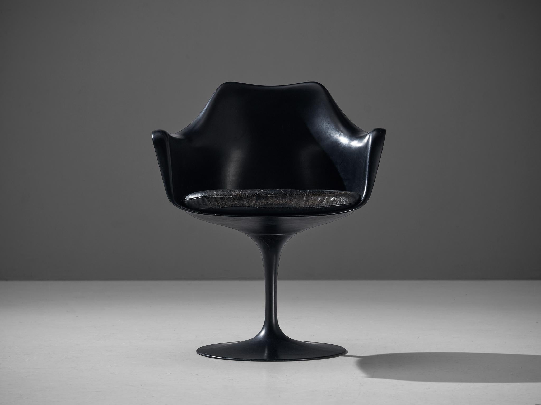 Eero Saarinen for Knoll, 'Tulip' armchair, fiberglass, aluminum and leather, United States, 1955-56.

This armchair with patinated black leather is from the 'Tulip' collection and was designed by Eero Saarinen for Knoll International. This iconic