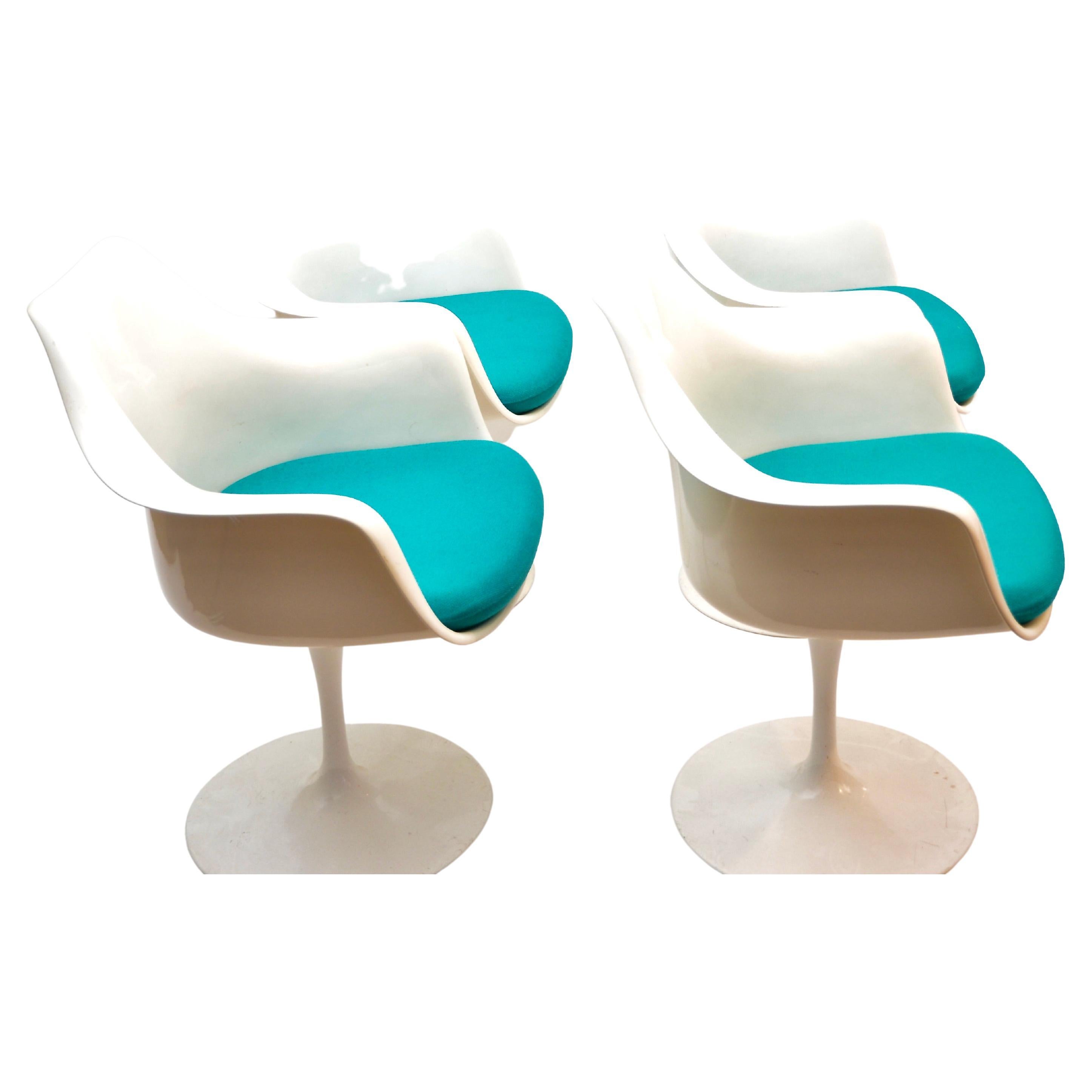 Tulip armchair by Eero Saarinen for Knoll International. Moulded fibreglass shell and cast aluminium base. 
Its organic shape remains timeless and elegant. 
Set of 4 armchairs.

Eero Saarinen was a Finnish American Industrial designer and