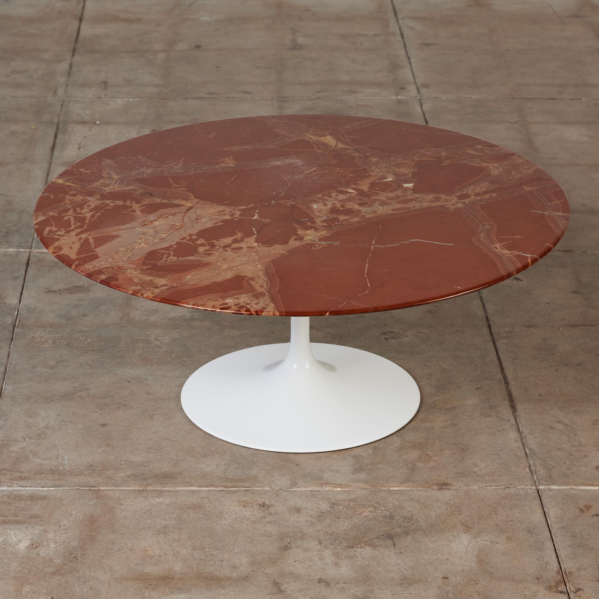 The tulip table is one of Saarinen’s most iconic designs for Knoll, c.1957. This coffee table features an aluminum pedestal base and an impressive circular Russo Rubino marble top with white, cream and deep oxblood veining.

Made in