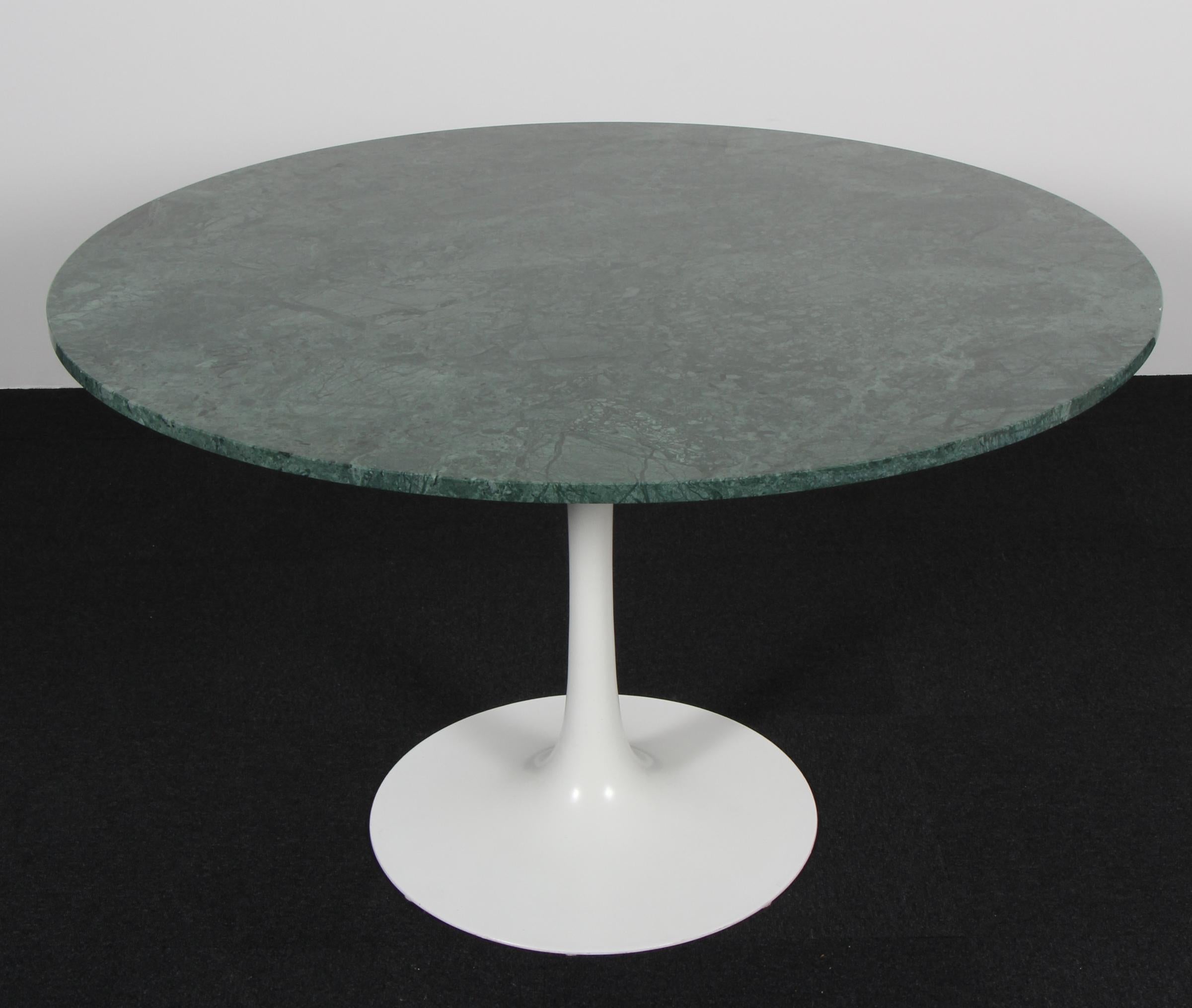 Eero Saarinen Tulip dining table with white base. New plate of green Guatemala Verde marble.

Manufactured by Knoll International.