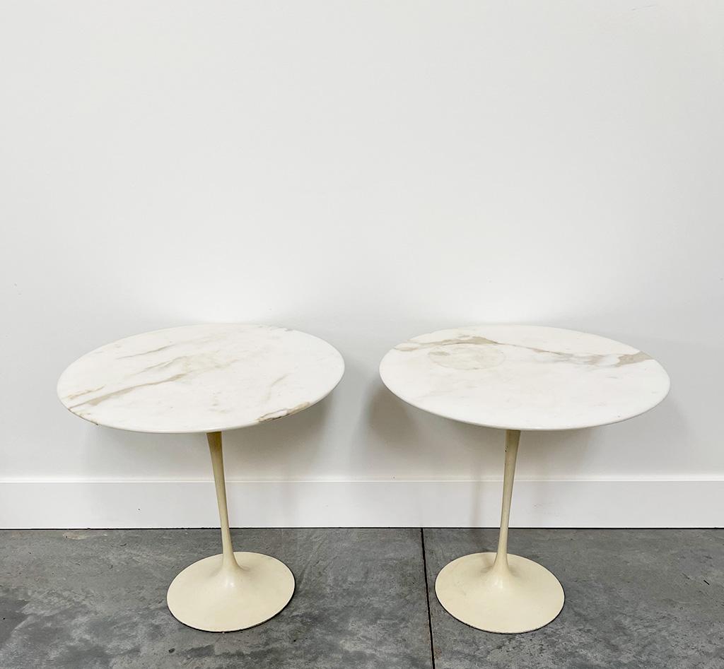 Beautiful pair of Eero Saarinen tulip style side or end tables. This mid century modern iconic design comes with Carrara marble tops and cast heavy bases in white.