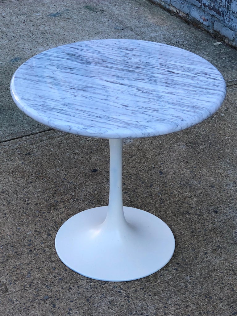 Gorgeous tulip side table in the style or Eero Saarinen for Knoll. Base made by Burke and the top is a freshly cut custom slab. White Carrara marble from Italy with full rounder “bullnose” edge. Measures approximately 23 inches tall and wide.